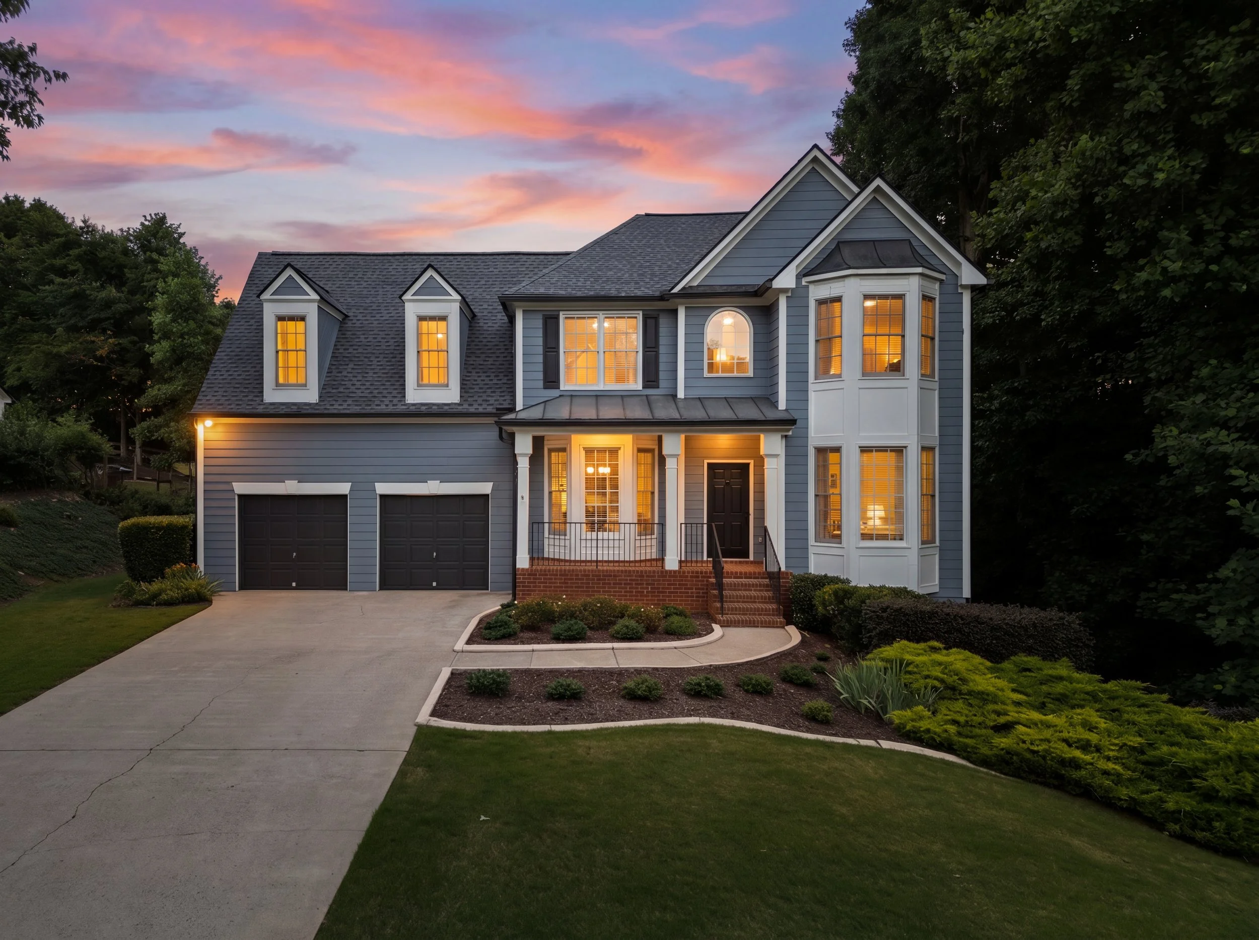 Exterior of 9610 Eagles Landing Drive in Gainesville, Georgia, a two-story home with blue siding, white trim, front porch, two-car garage, and evening sky, listed with 3 bedrooms, 2.5 bathrooms, and priced at $447,999