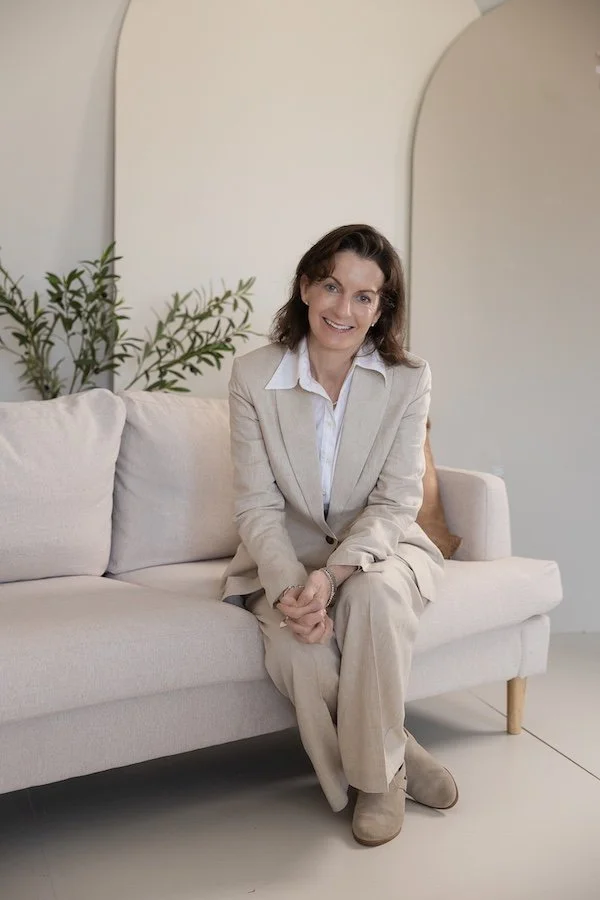 woman in tan suit on coach