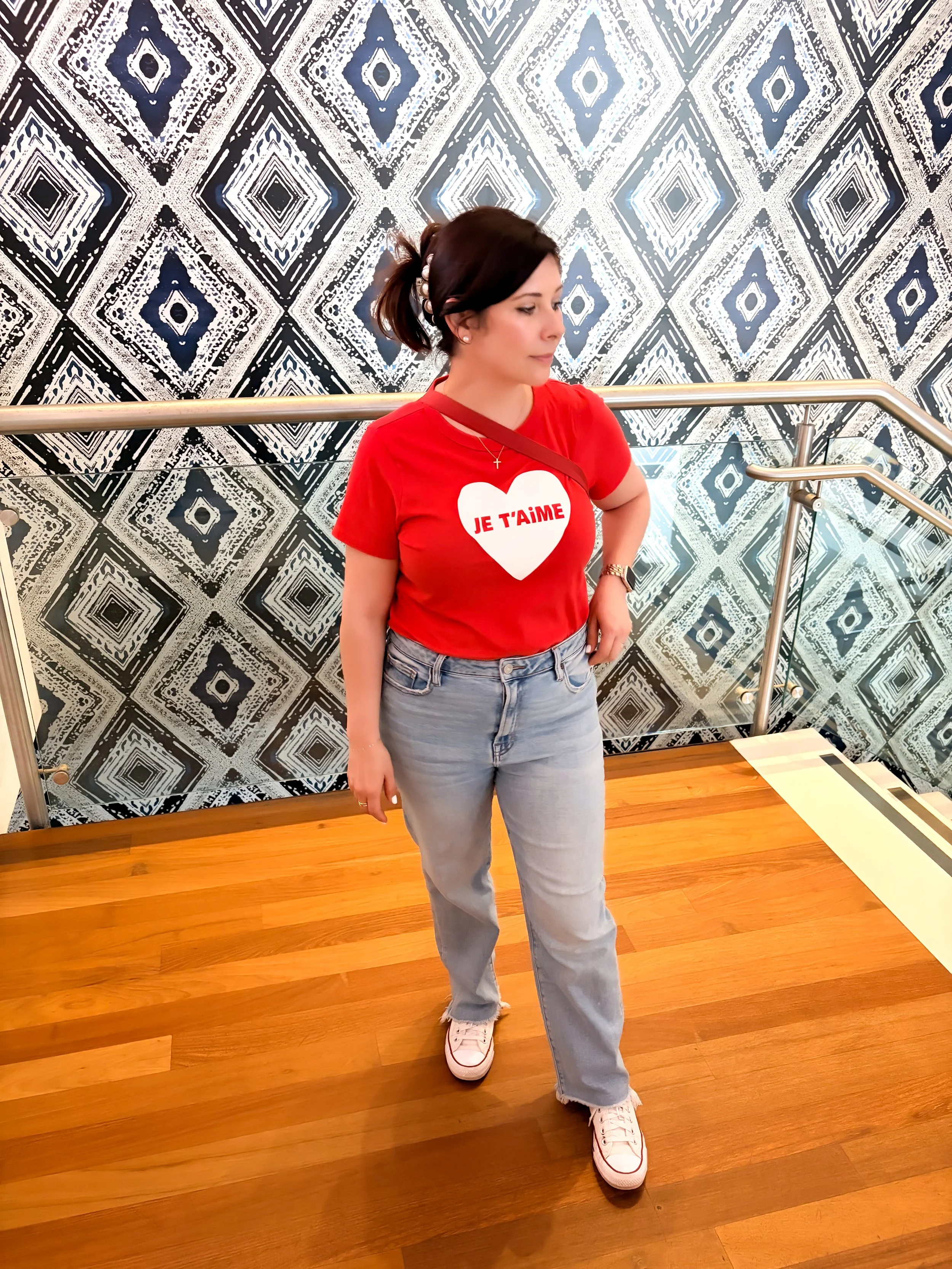 Girl with casual light wash jean outfit and red shirt