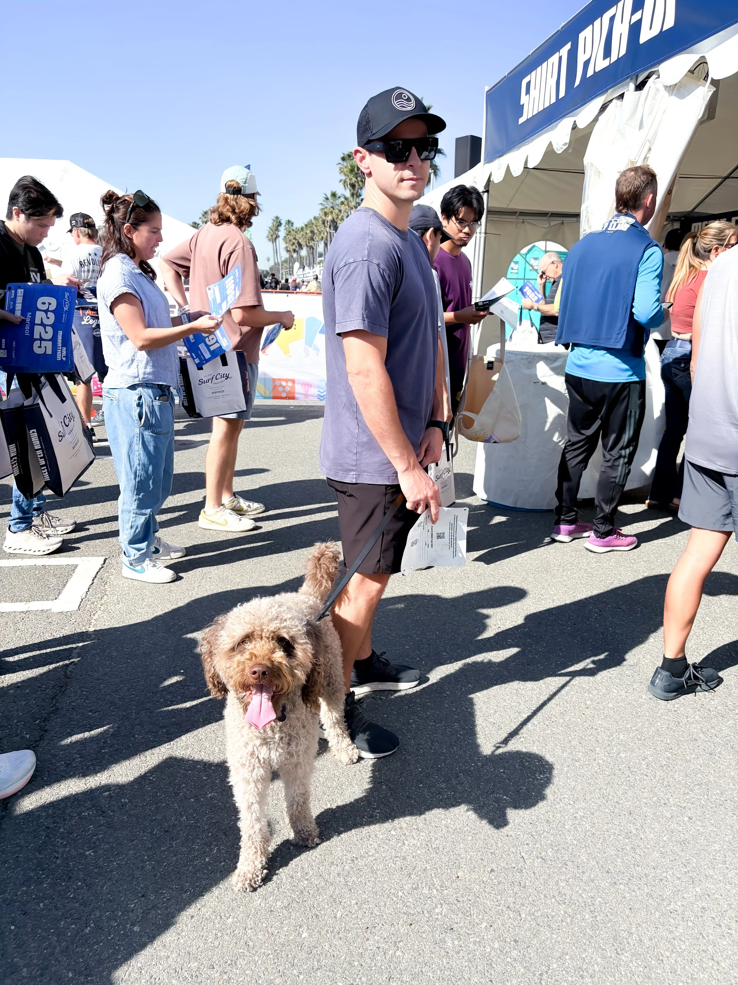 Man and Dog waiting to pick up race packet at the Huntington's beach surf city marathon