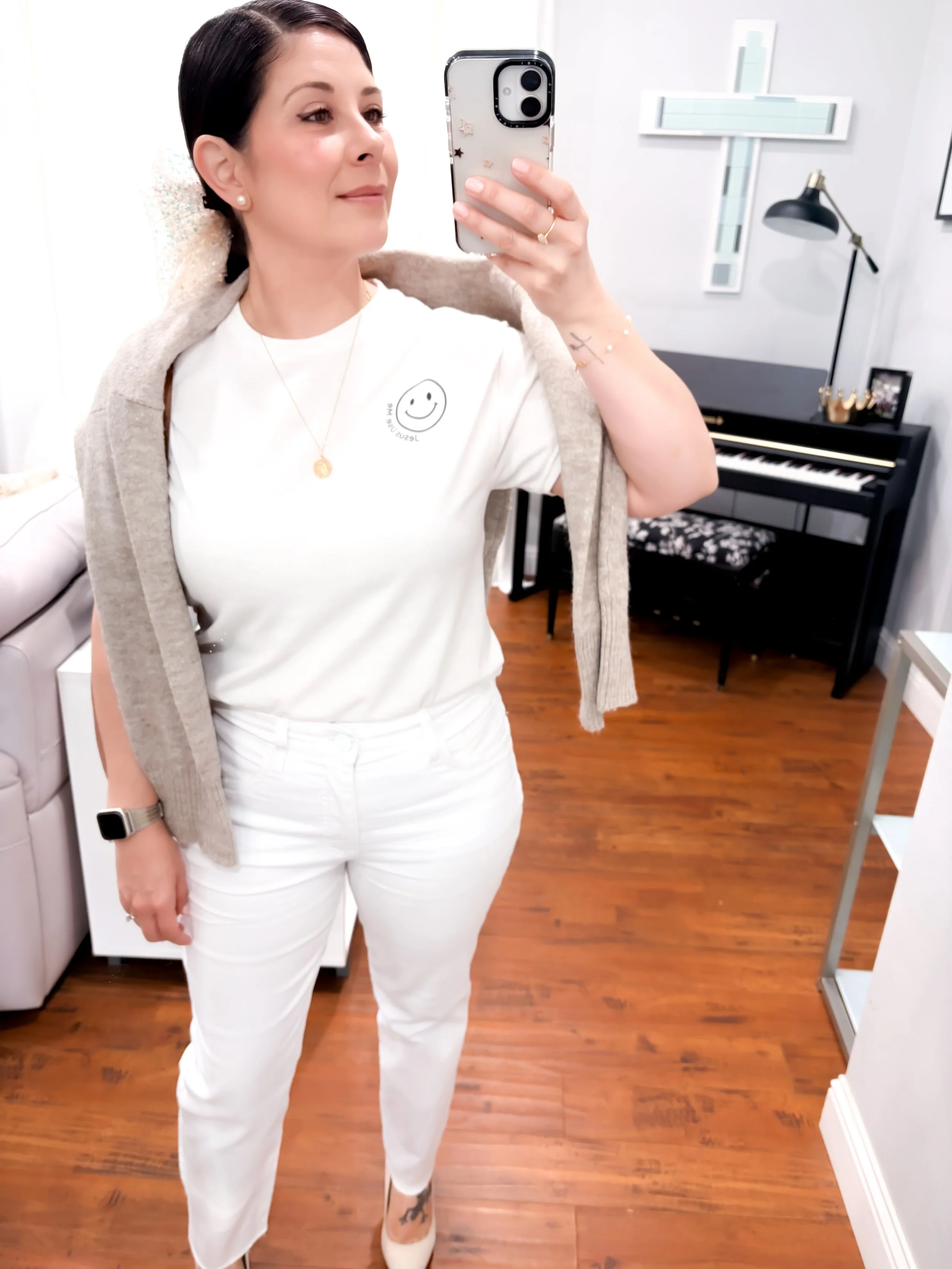 A Jesus use me white tee shirt with smilie face on a woman wearing a chic all white outfit