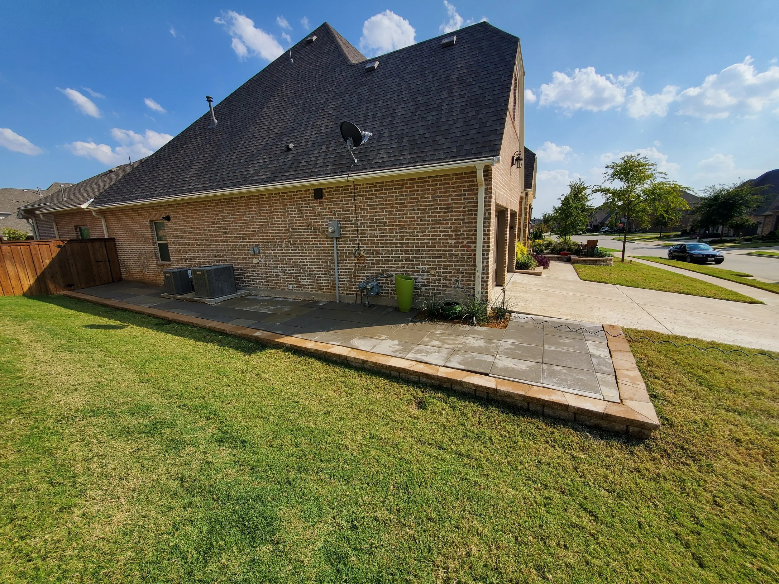 (Front Yard Angle) A concrete paver walkway that wraps entirely around the house, starting from the front driveway and ending all the way at the back porch. This replaced a decomposed granite walkway with minimal pavers that left a mess everywhere.