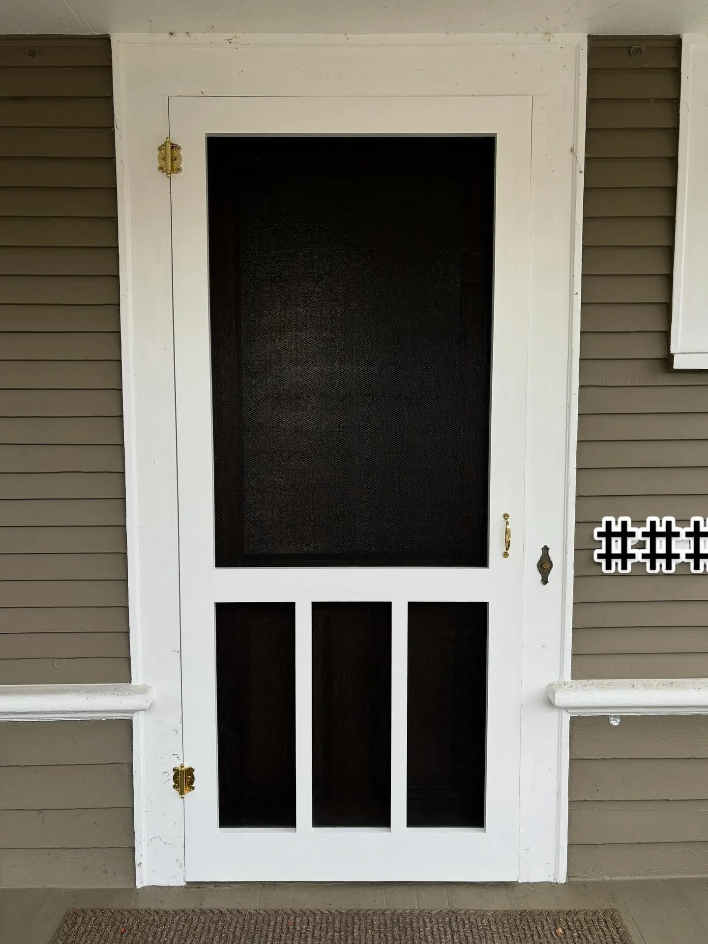 This pair of custom screen doors was built for a veteran homeowner. The design mirrors the lines of the railing that lead up to the porch, and the crisp white paint ties in beautifully with the existing trim. A pop of gold hardware adds warmth and ju