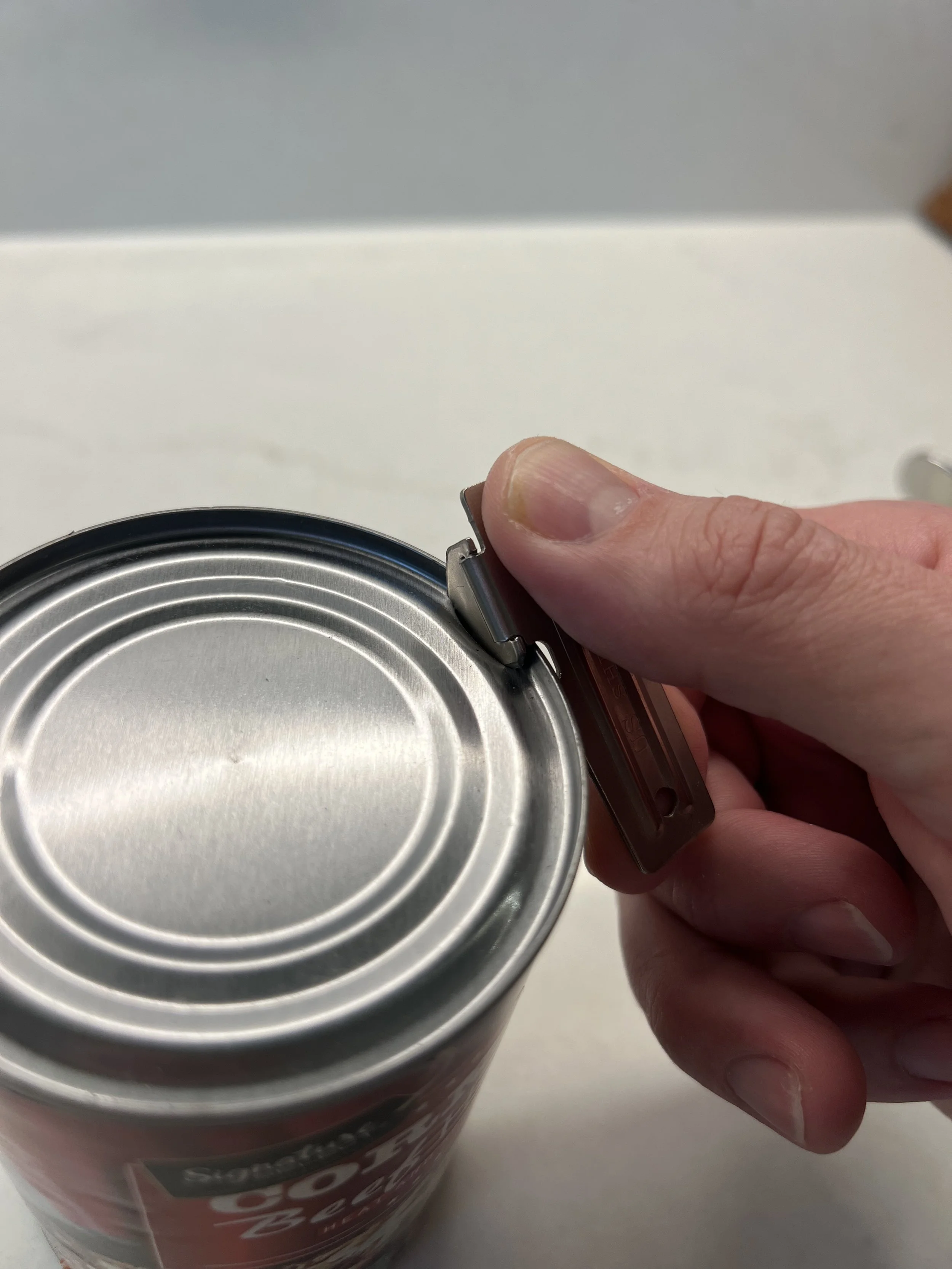 Push down and pierce the can with a P-38 can opener