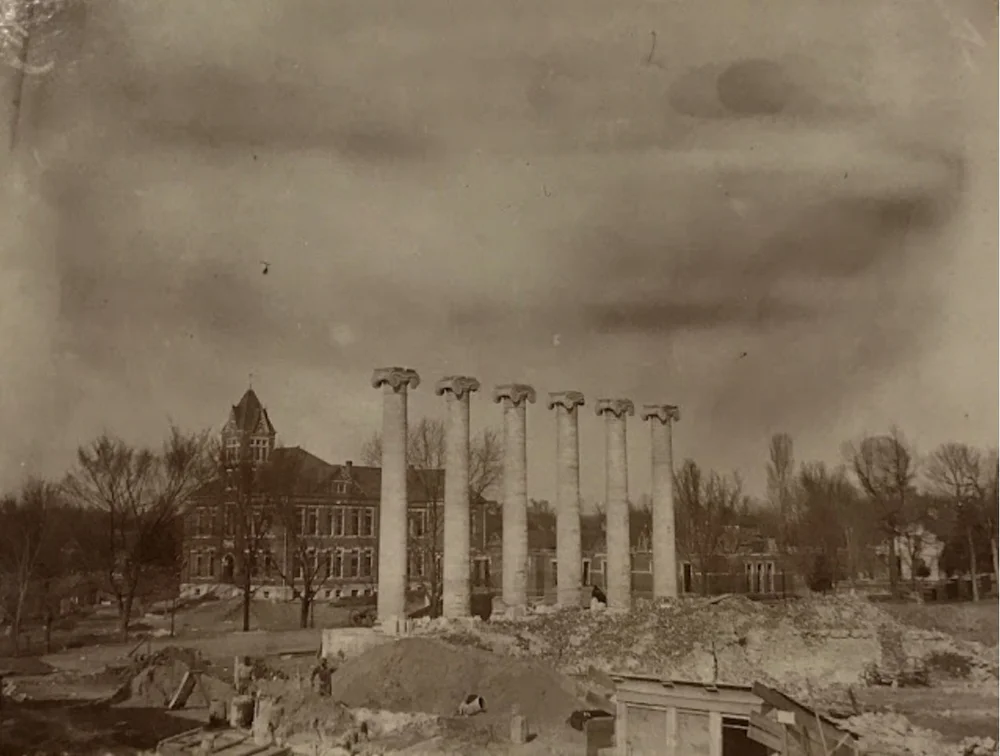 The remaining walls were dynamited. A newly completed Law Building and partially completed Pickard Hall can be seen in the background. From the State Historical Society of Missouri