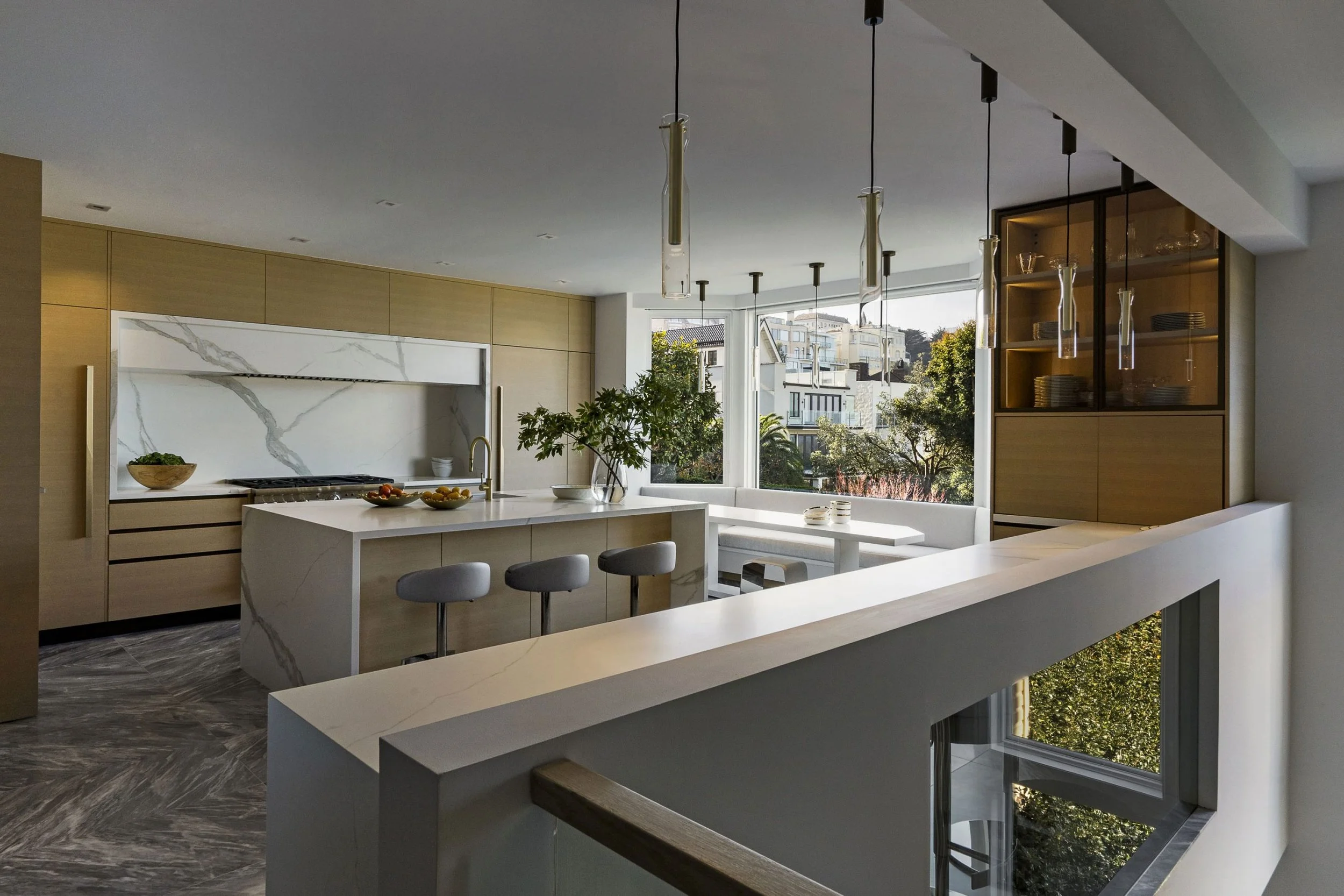 Golden Gate bridge view from a Pacific Heights post war remodel, modern kitchen with banquet seating in bay window.  