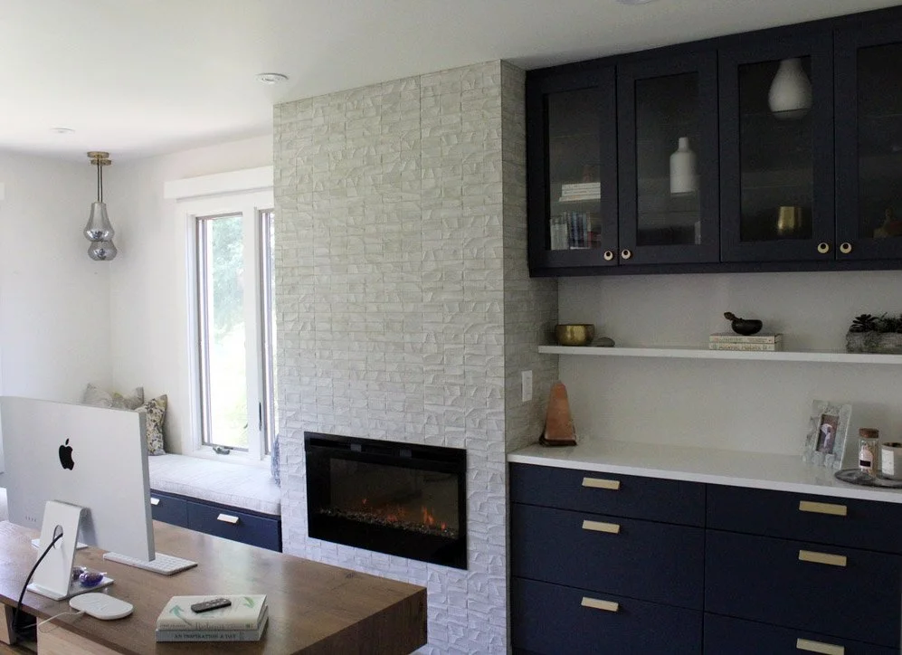 Sleek home office with deep blue frameless cabinets, a patterned tiled fireplace, and clean, modern design elements