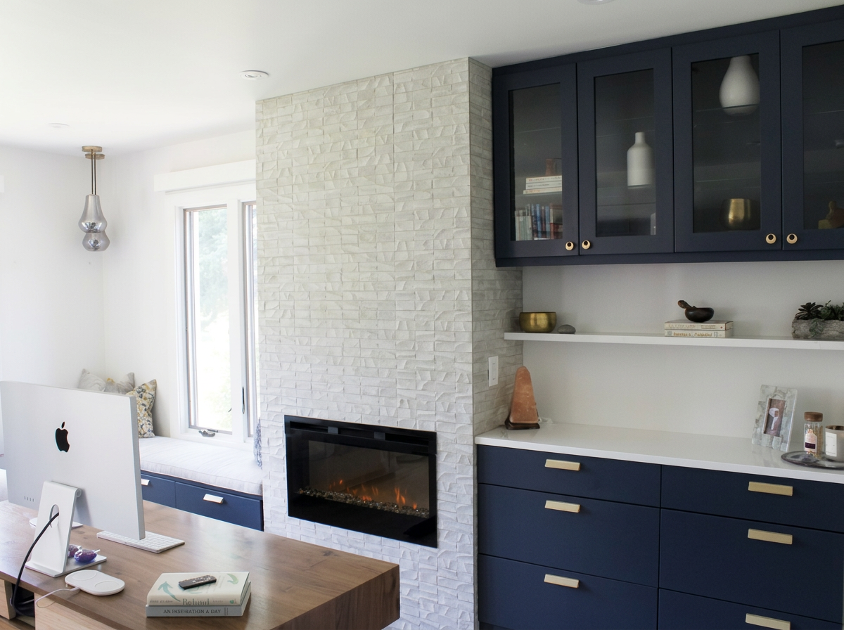 modern home office with built in fireplace and ample storage cabinetry.