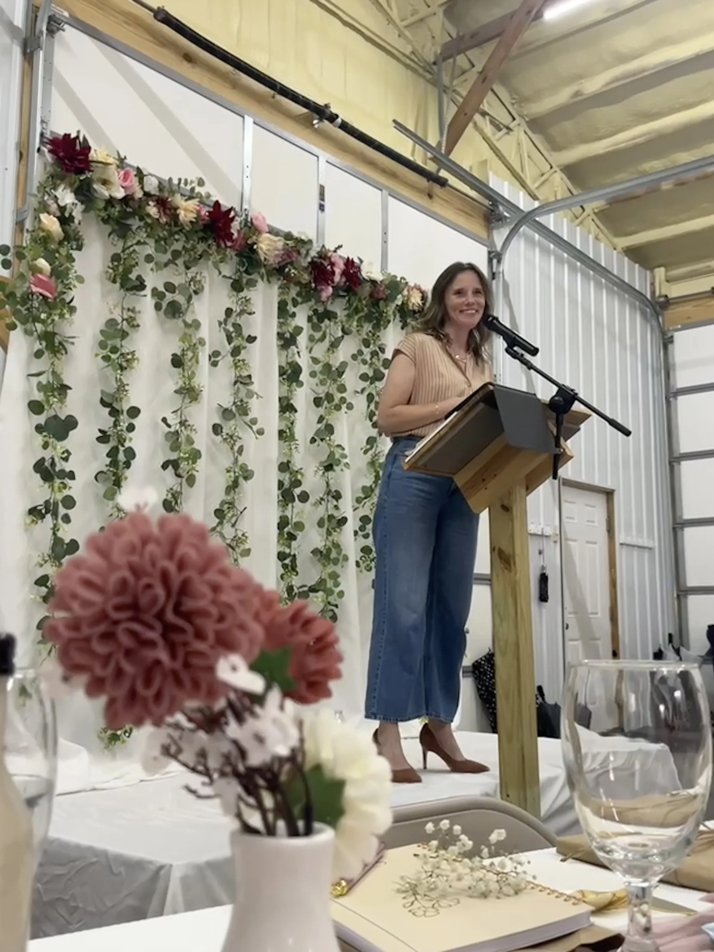 Amy Eaton Author, Christian Speaker, speaking at Women's Ministry Event with floral decor in large industrial building for Ladie's Conference on Hope