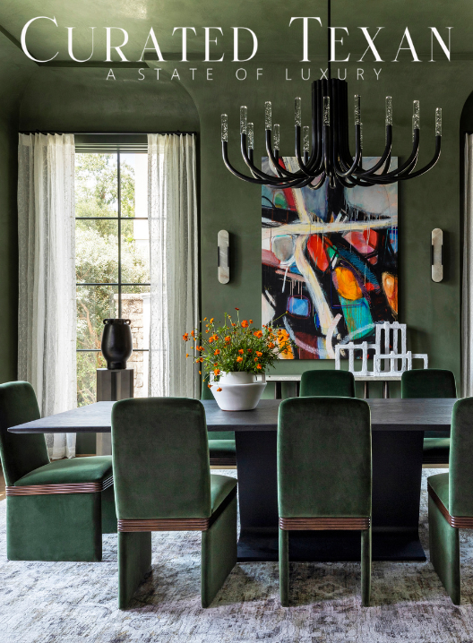 Elegant dining room with dark green walls, six matching green chairs around a black table, a white vase with orange flowers, a black vase on the window ledge, a large window with sheer white curtains, an abstract art painting, and a black chandelier.