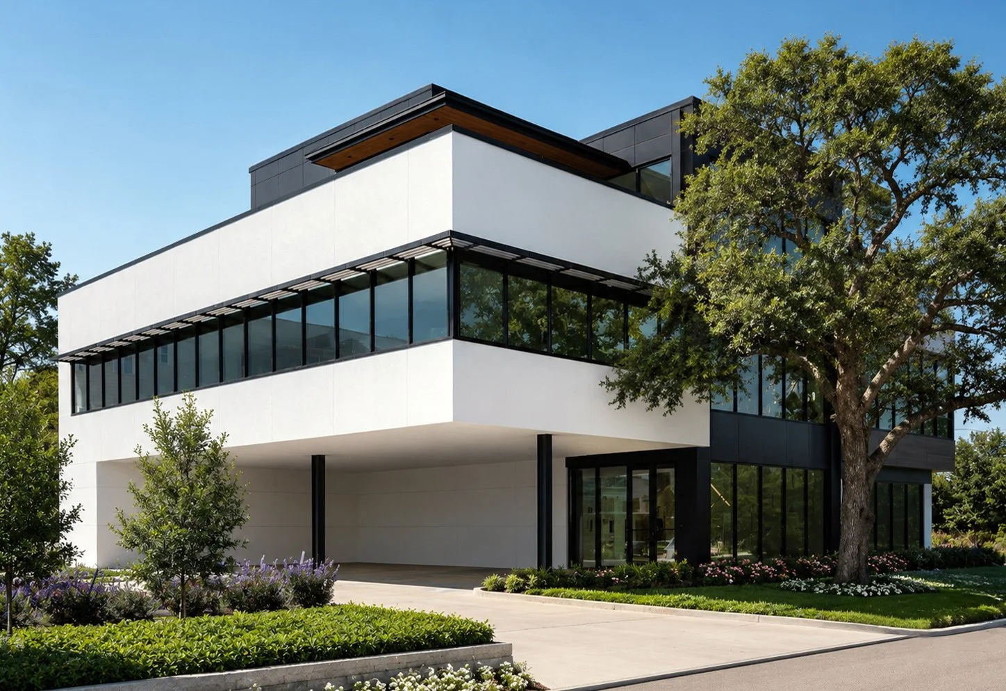 Benjamin Johnston Design Houston interior design studio exterior at 5301 Katy Freeway featuring modern architecture with white stucco facade, floor-to-ceiling black steel windows, and manicured landscaping.