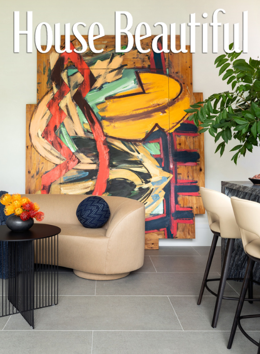 Benjamin Johnston Design featured in House Beautiful — neutral living room with bold abstract art, beige sofa, and black accents.
