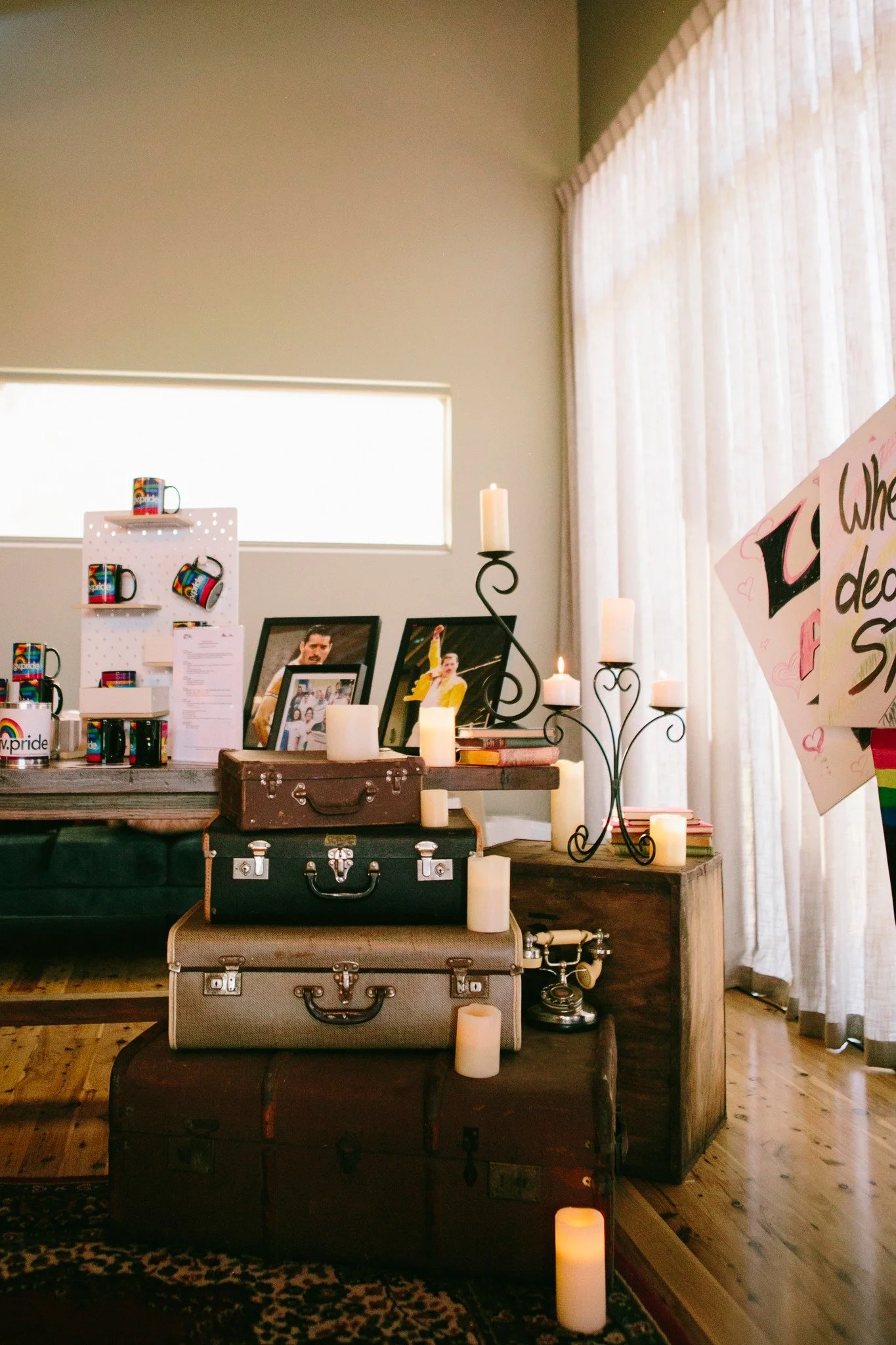 A room filled with luggage and a sign that reads 'Pride Ball'.