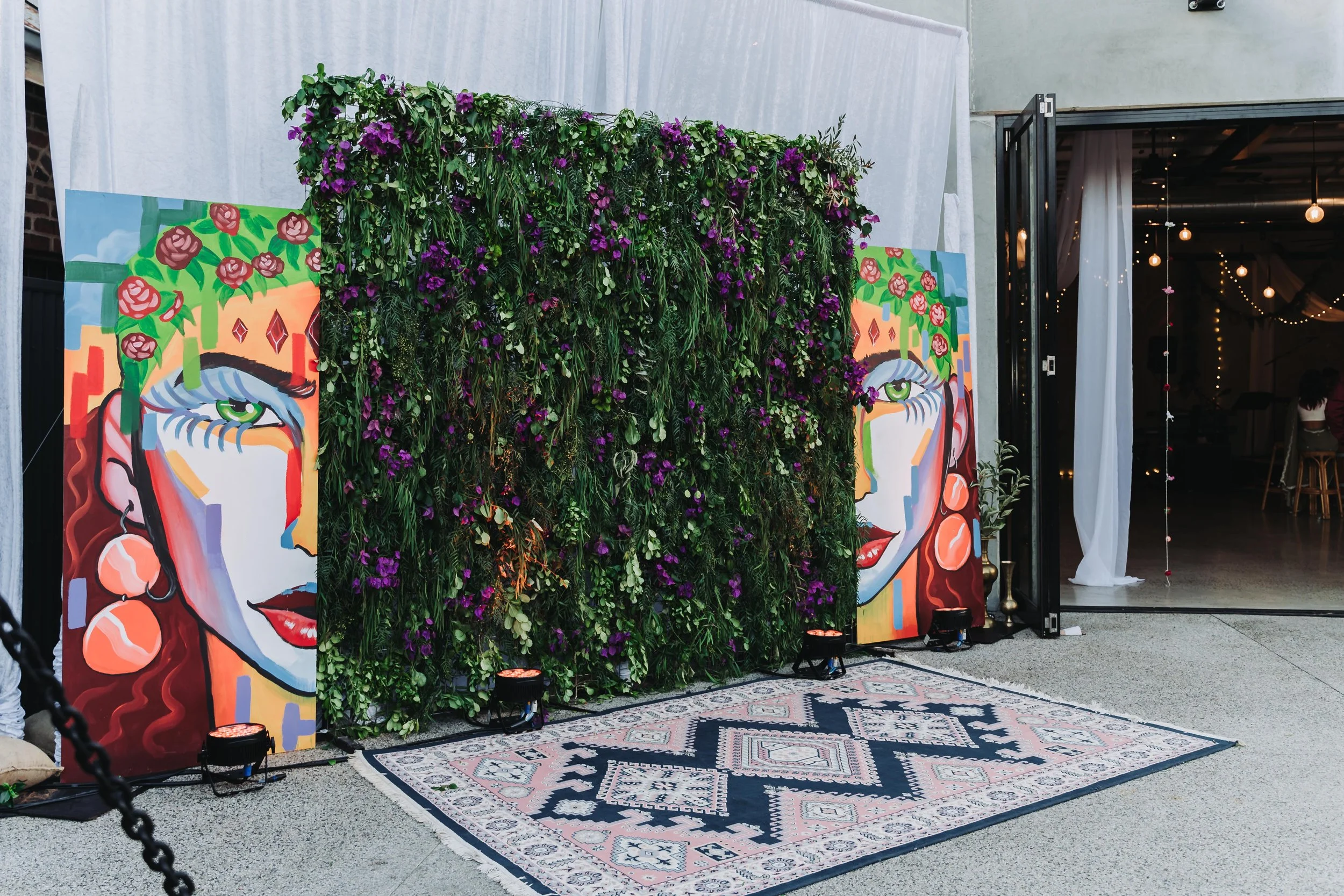 A vibrant mural and a rug placed before a door, creating a lively and inviting atmosphere.