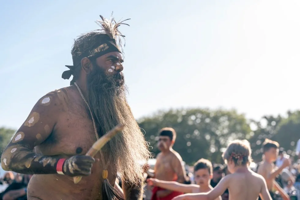 A man with a long beard and a tribal headdress.