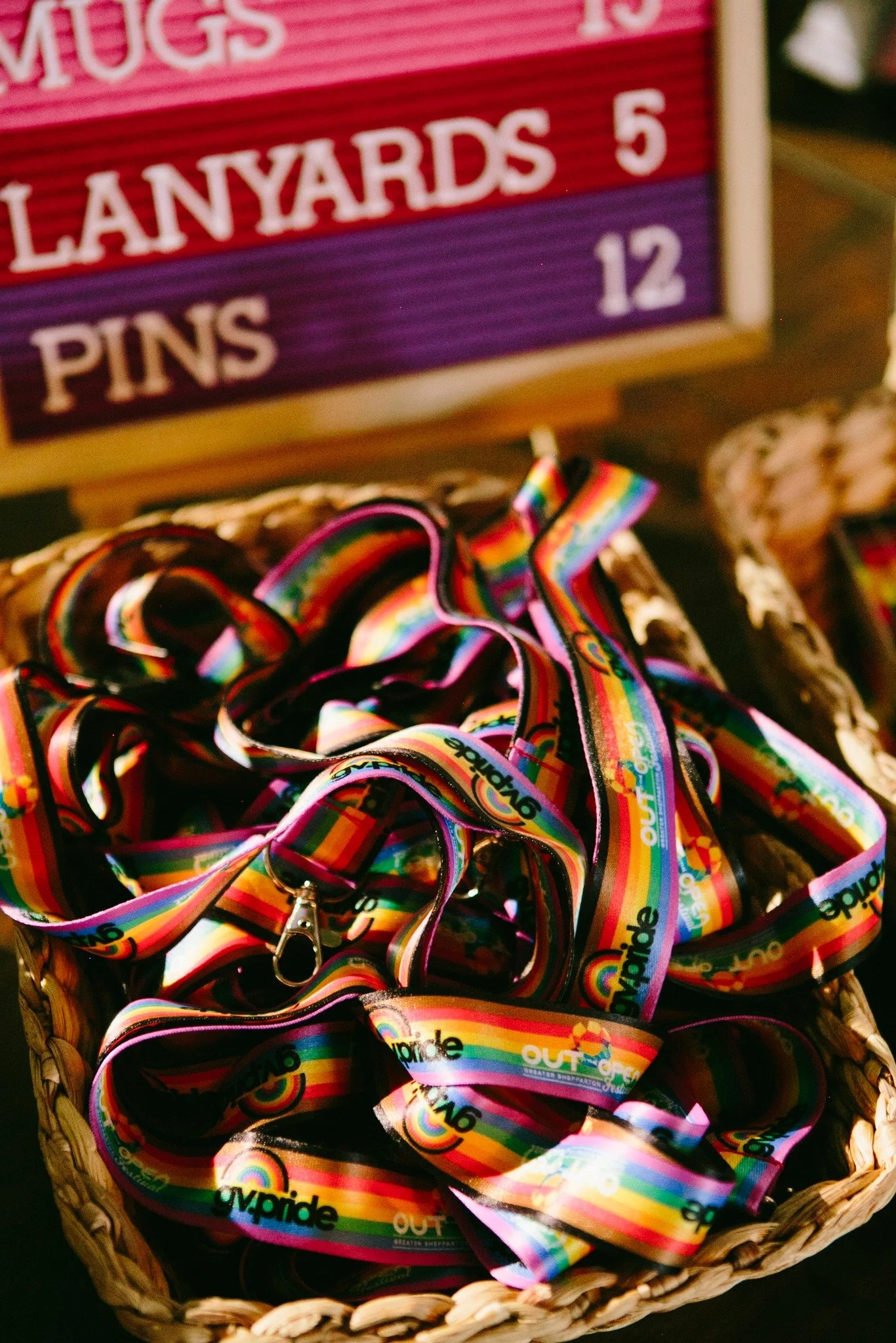 Basket filled with colorful lanyards, great for Pride Ball occasion.