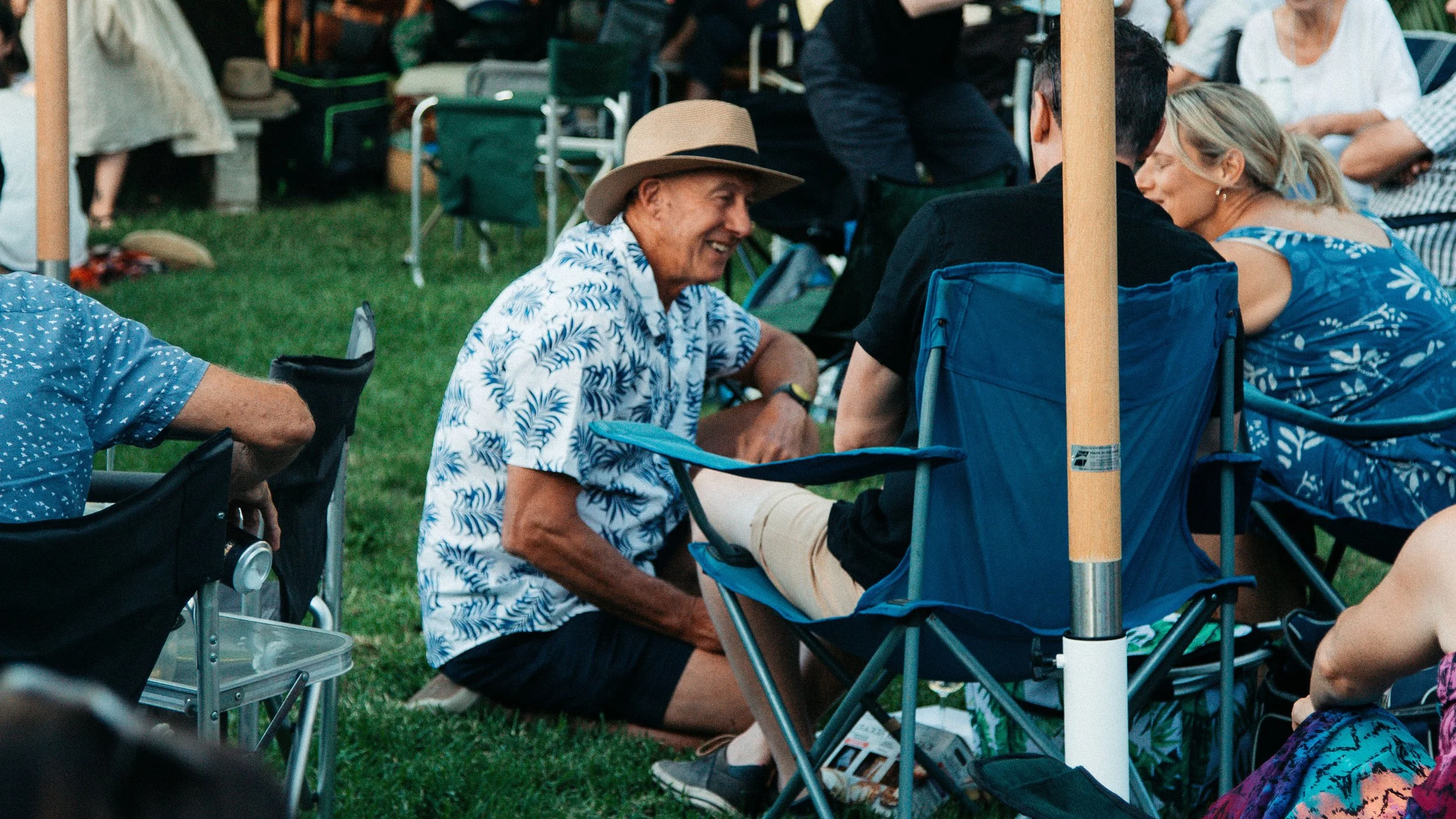 People sitting in lawn chairs at a Secret Garden Gig.
