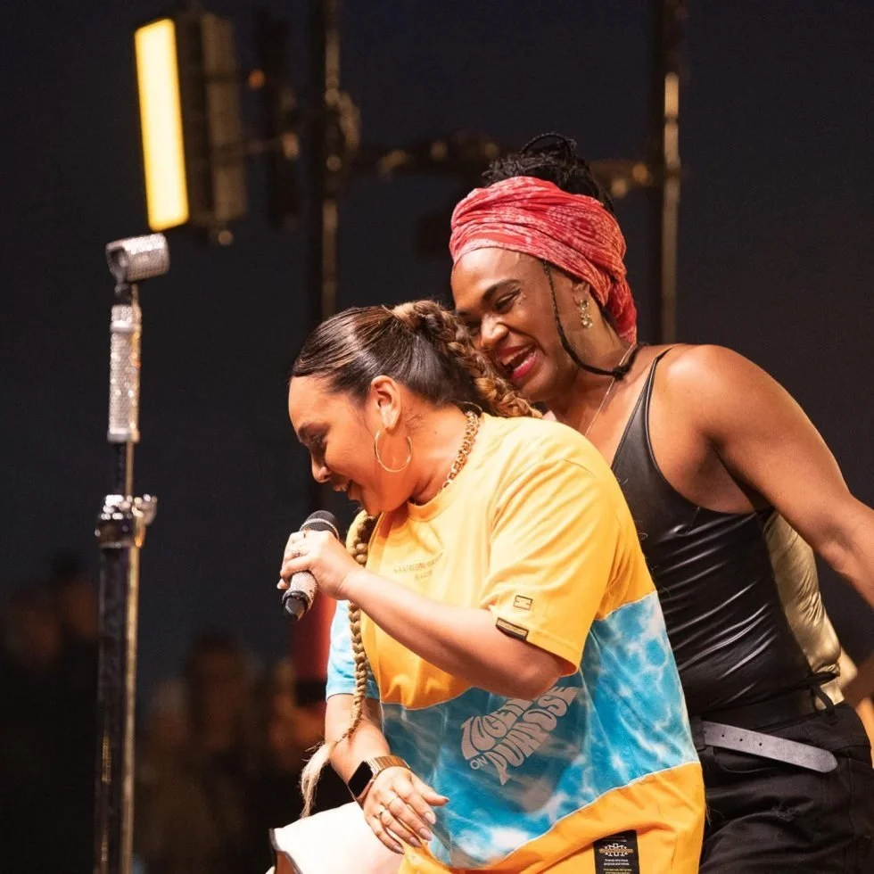 Jessica Mauboy & Zaachariaha Fielding  performing on stage, singing into microphones at Treaty Day Out event.