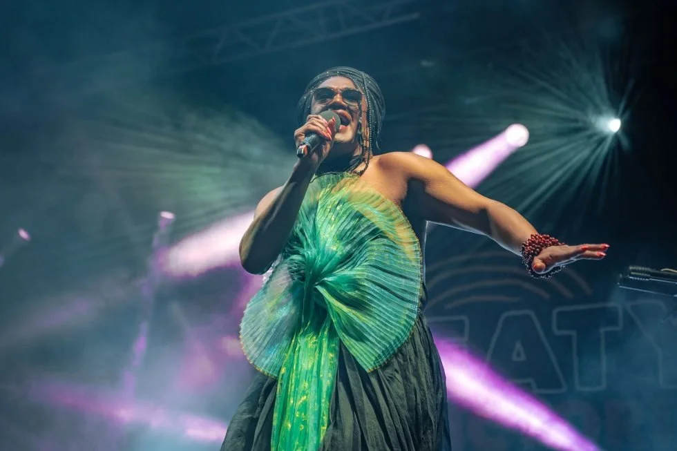  Zaachariaha Fielding in a green dress passionately singing on stage during the Treaty Day Out event.