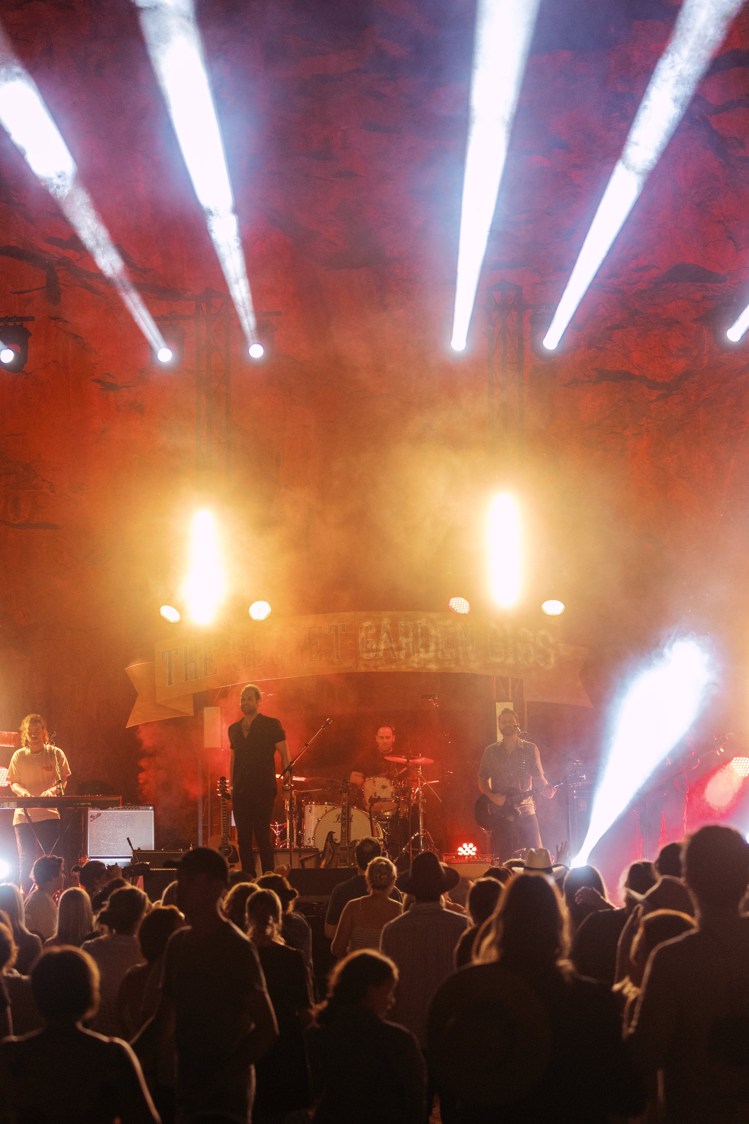 A band stands on stage bathed in warm light.