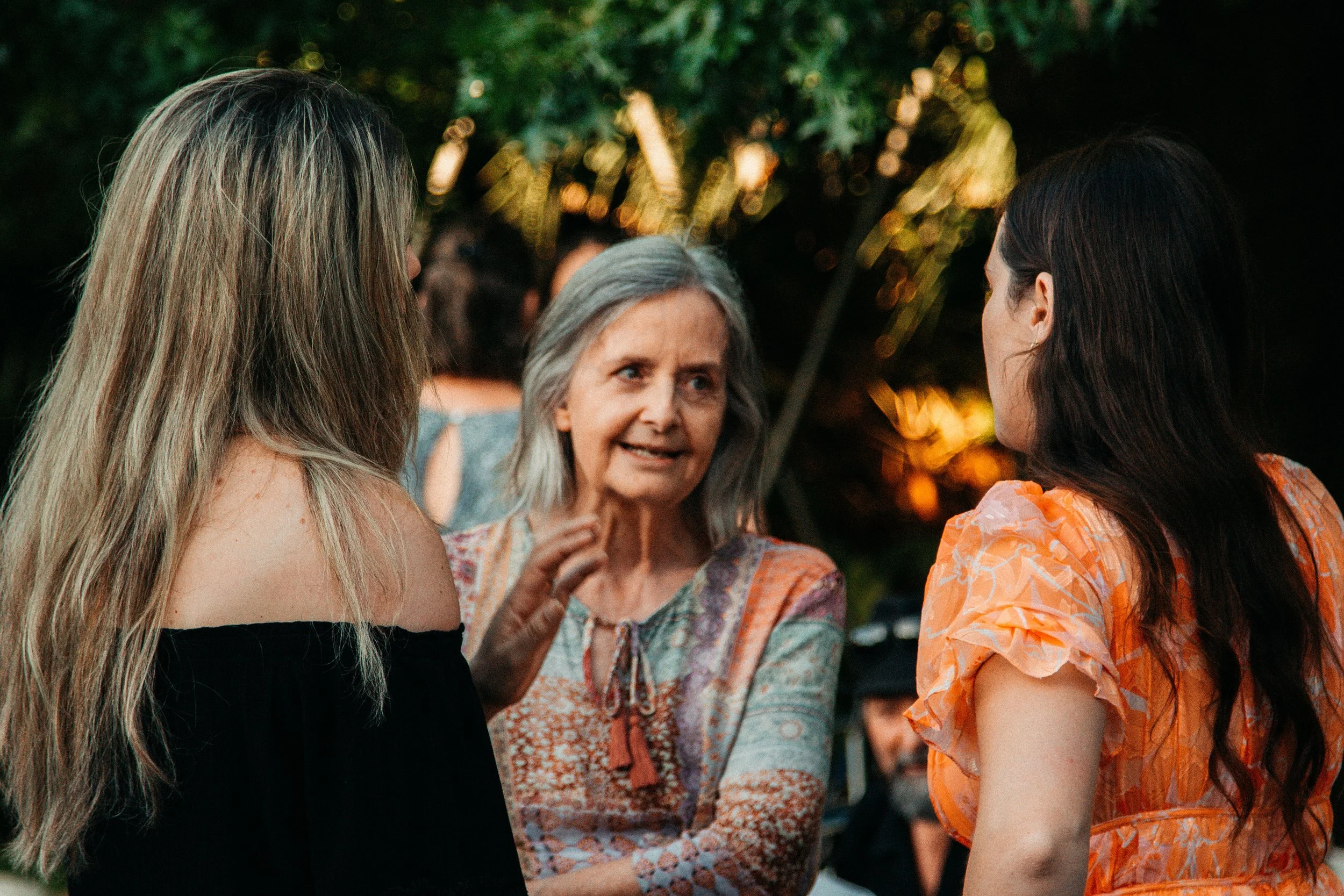 Women discussing in an outdoor environment.