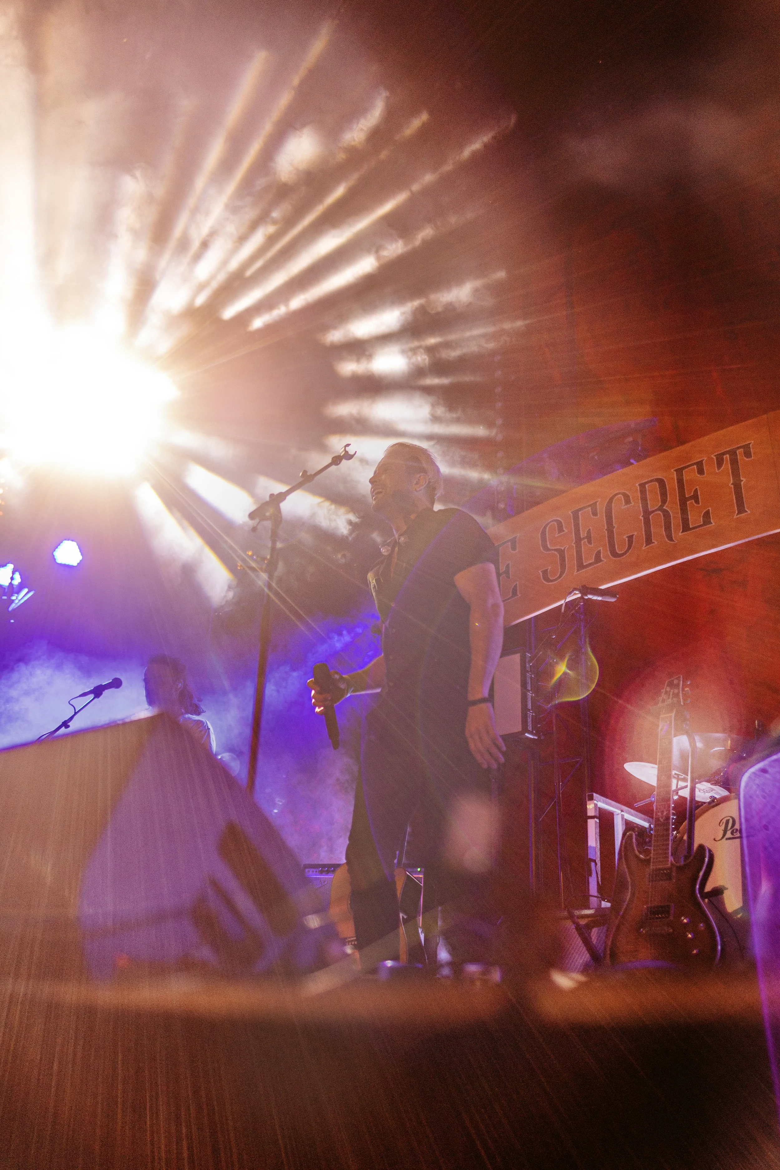 A man singing with a complex lighting display.