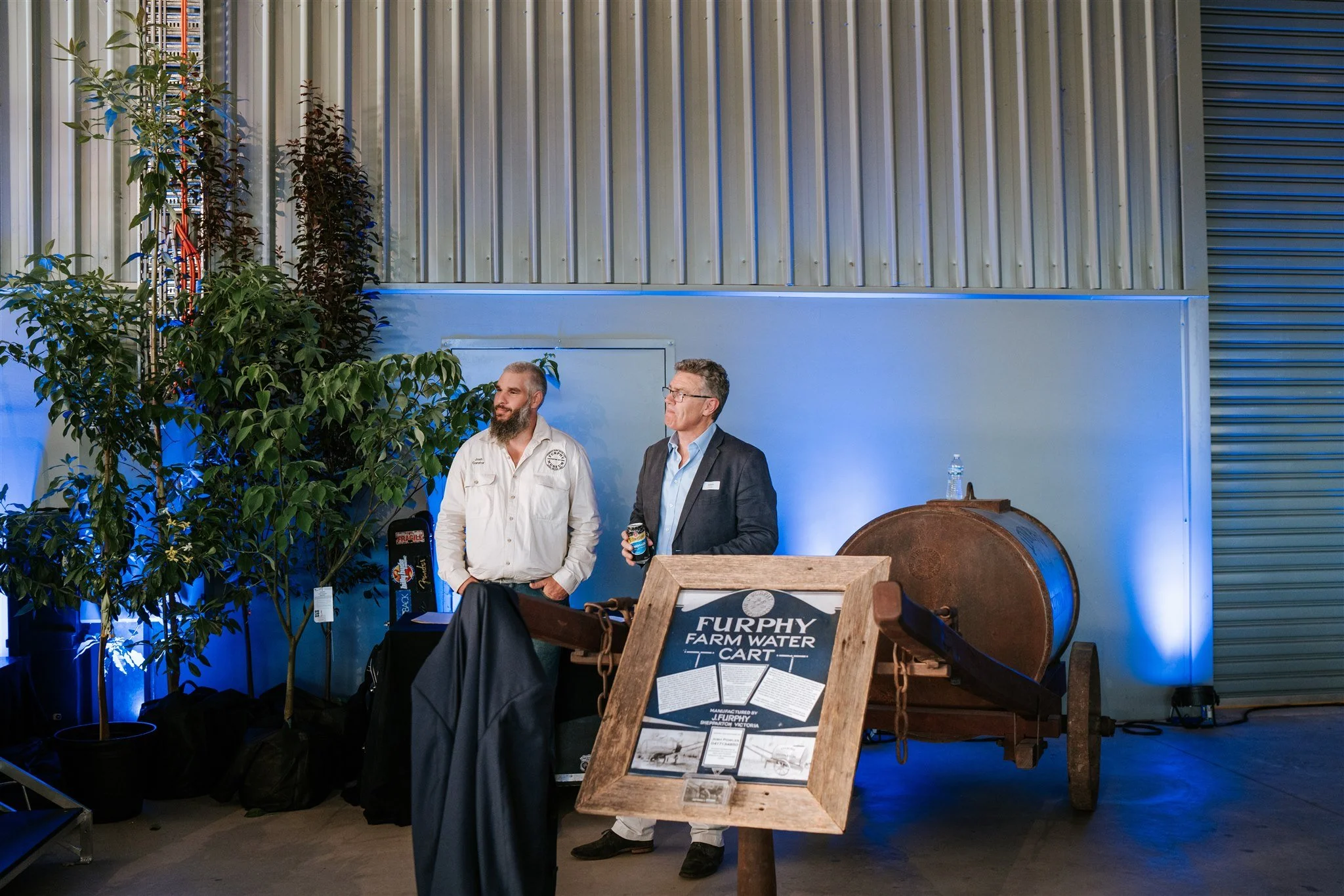 Furphy 150 Year Celebration: People celebrating around a historic water cart, marking a century and a half of Furphy's success
