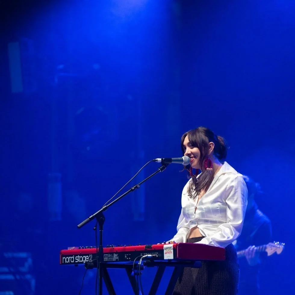 Alice Skye in white shirt playing keyboard at Treaty Day Out event.