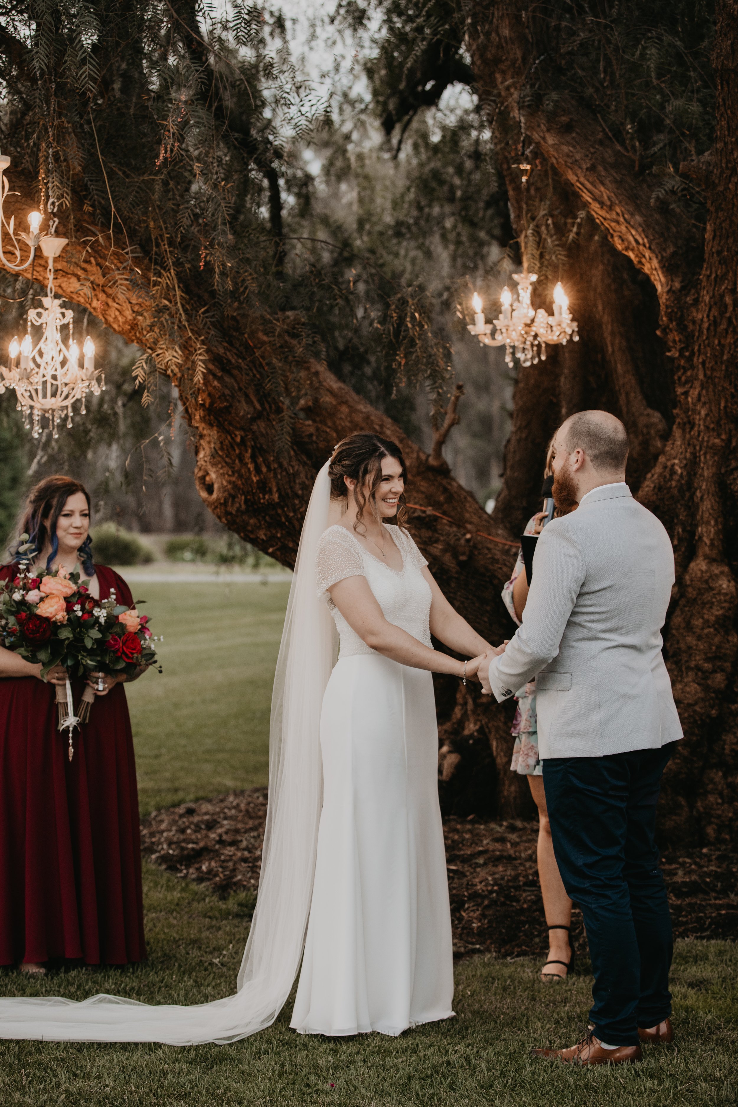 The Officiant marries the couple, as everyone laughs with joy.