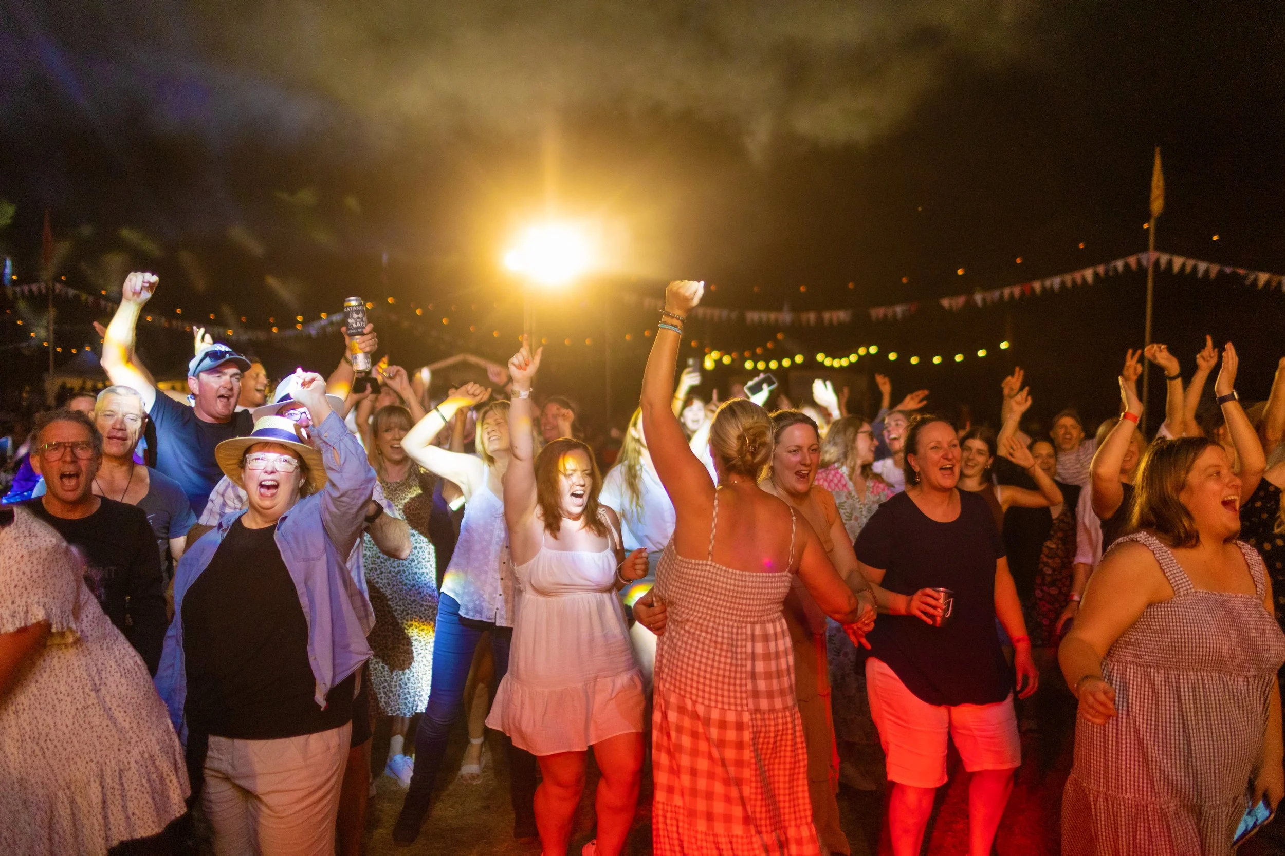 The crowd dances.