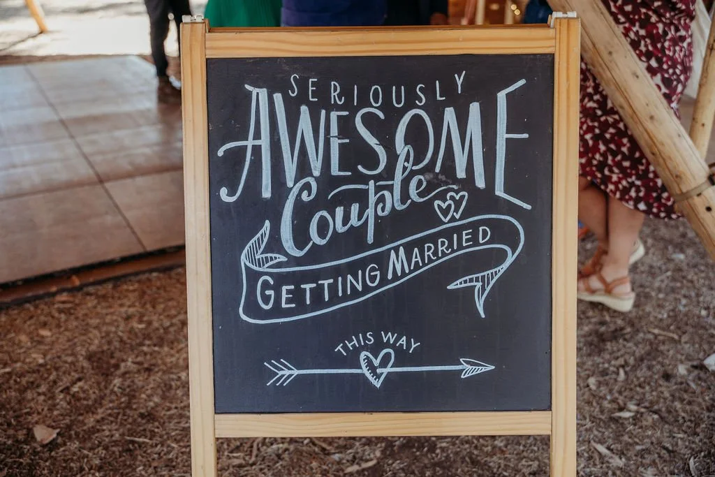 Wedding announcement on a chalkboard featuring the message "Awesome Couple Getting Married This Way" in Stylish Lettering