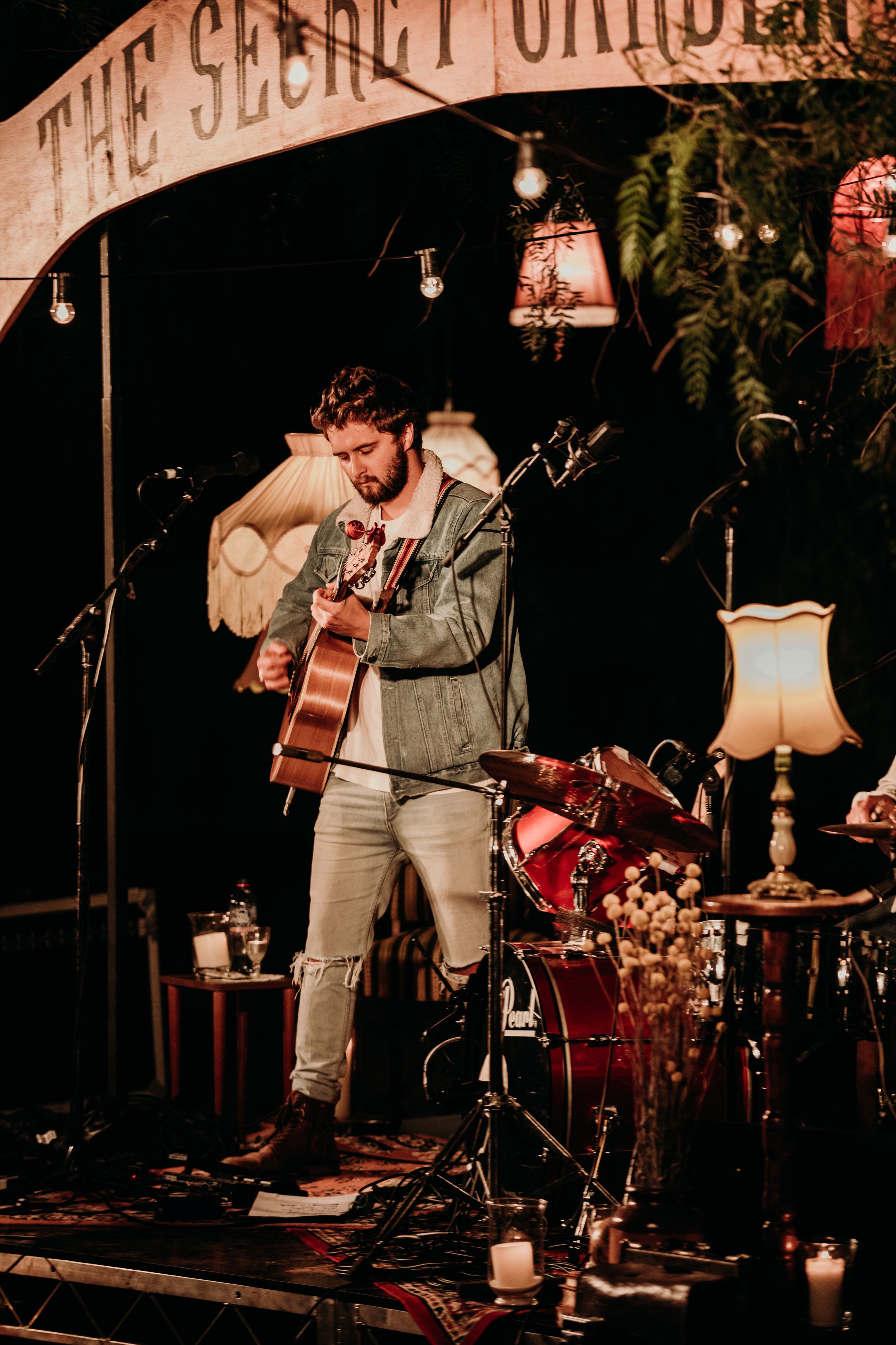 A man playing acoustic guitar enthusiastically. 