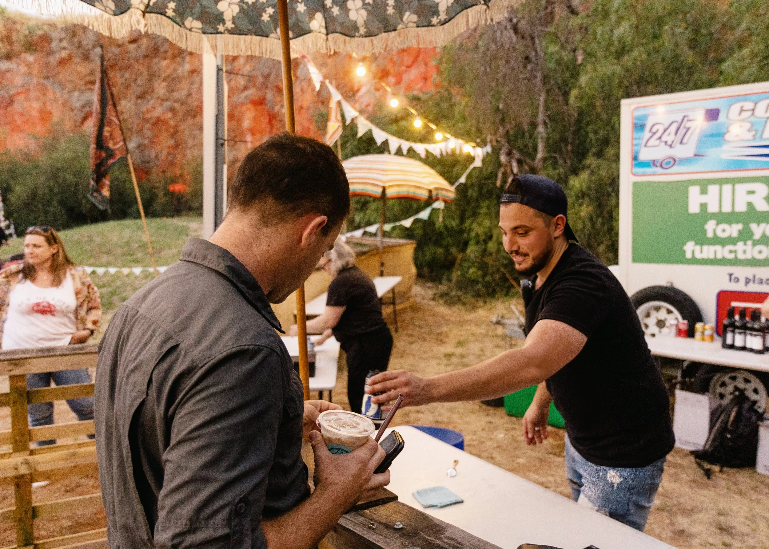 A man lining up to buy a drink.