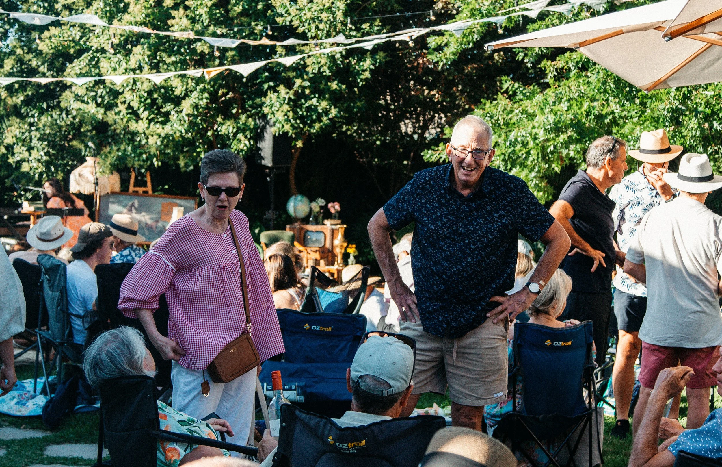  Attendees gathered outdoors for a lively event at a Secret Garden Gig.