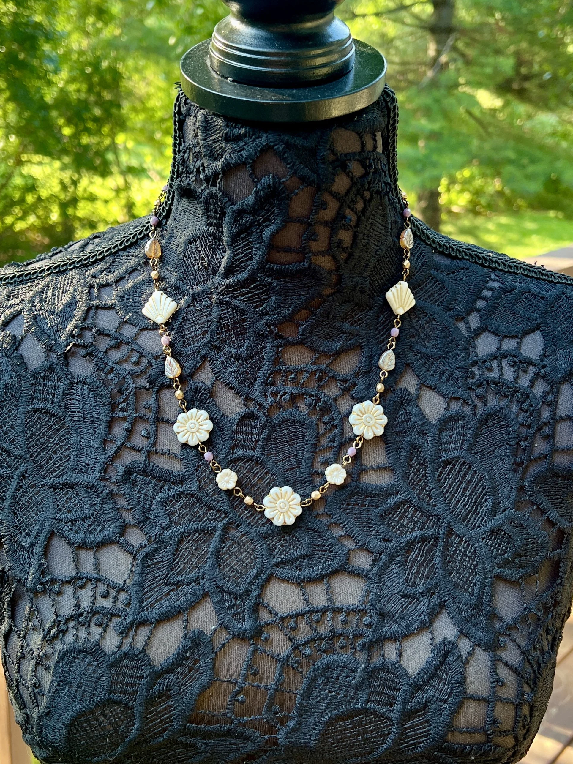 Handmade Czech glass necklace with ivory floral pressed beads and shell accents.