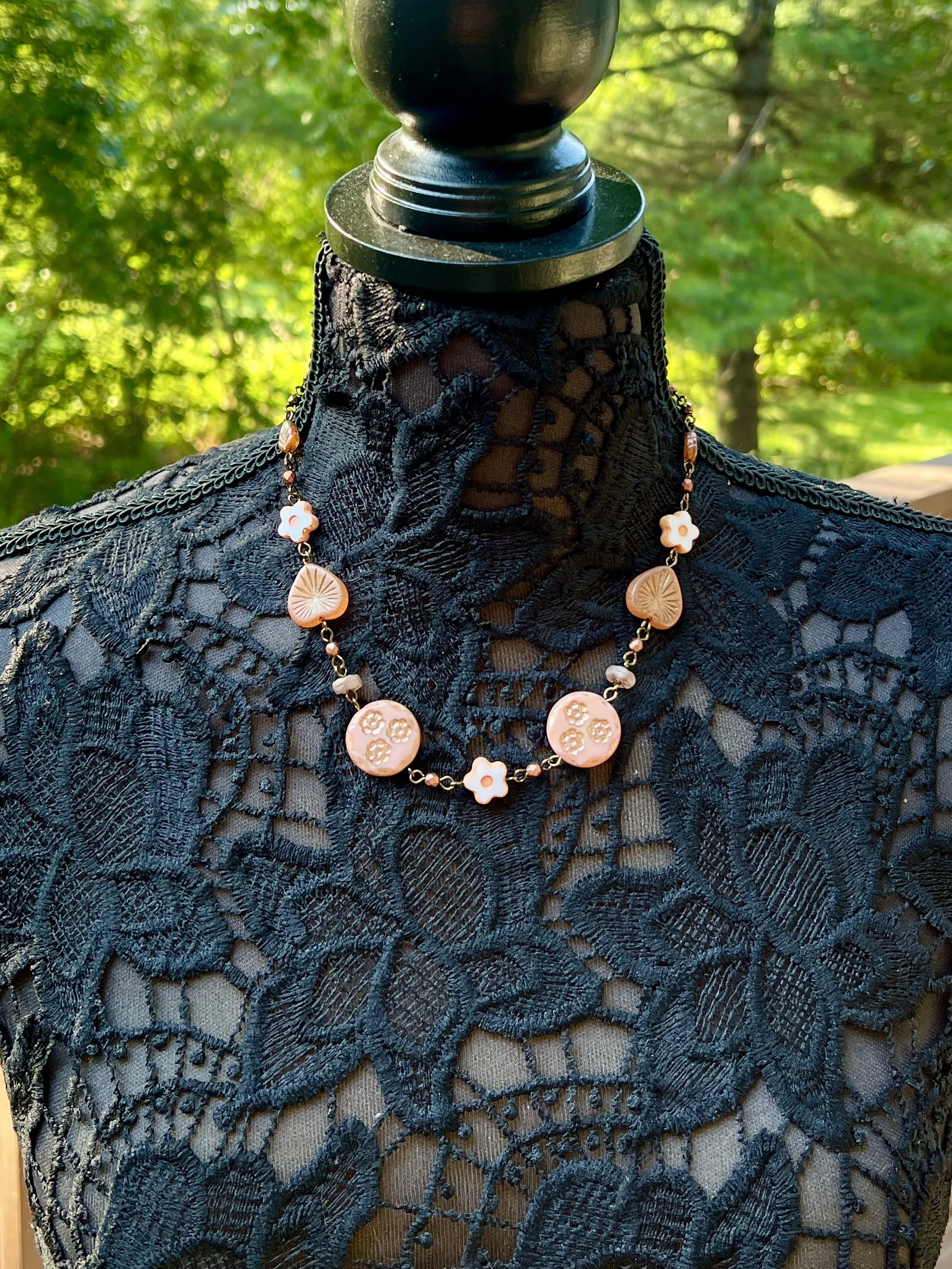 Handmade Czech glass necklace with pink floral pressed beads and gold accents.