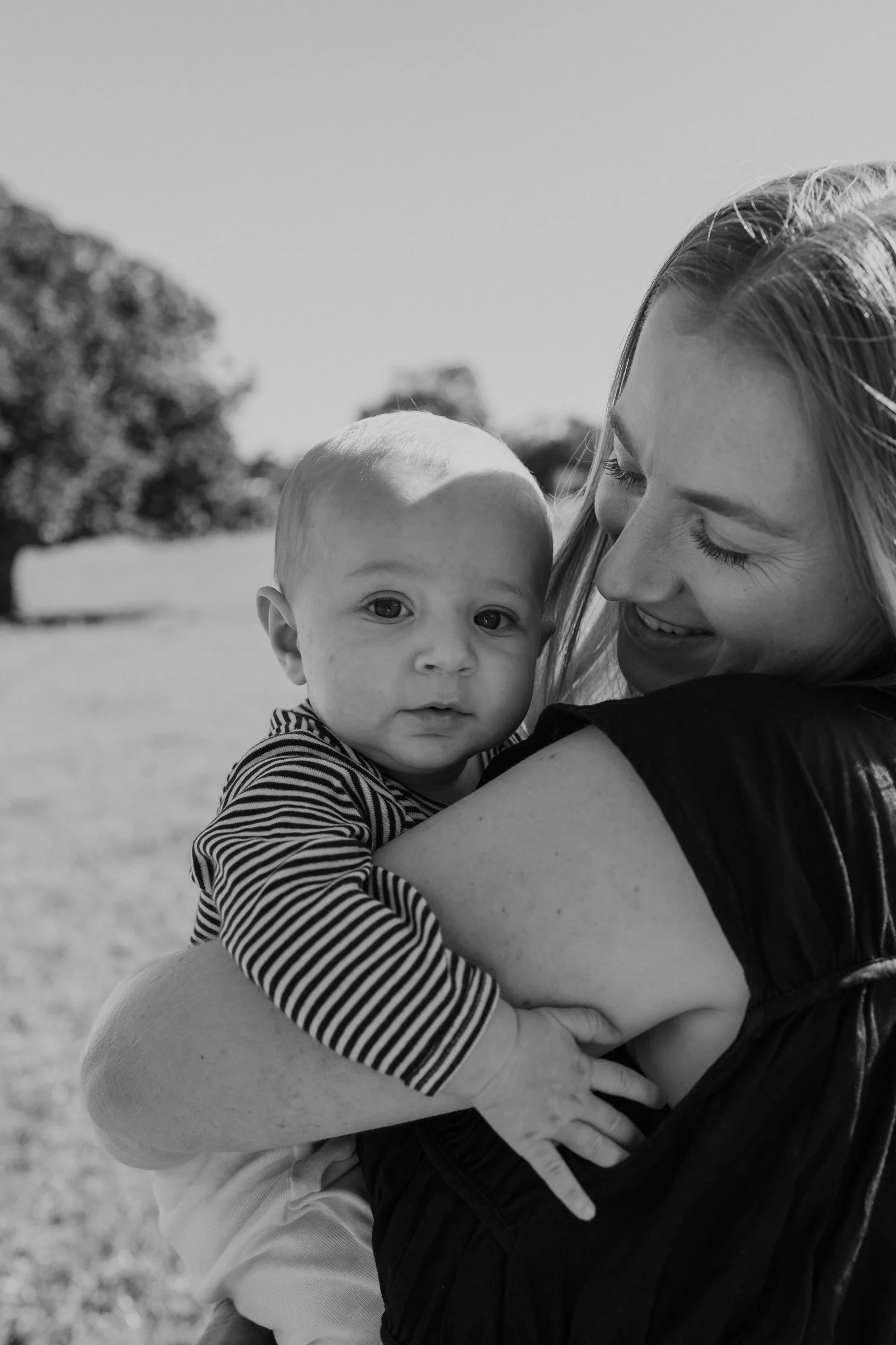 Mum hold's her son in natural family photography session in Auckland.