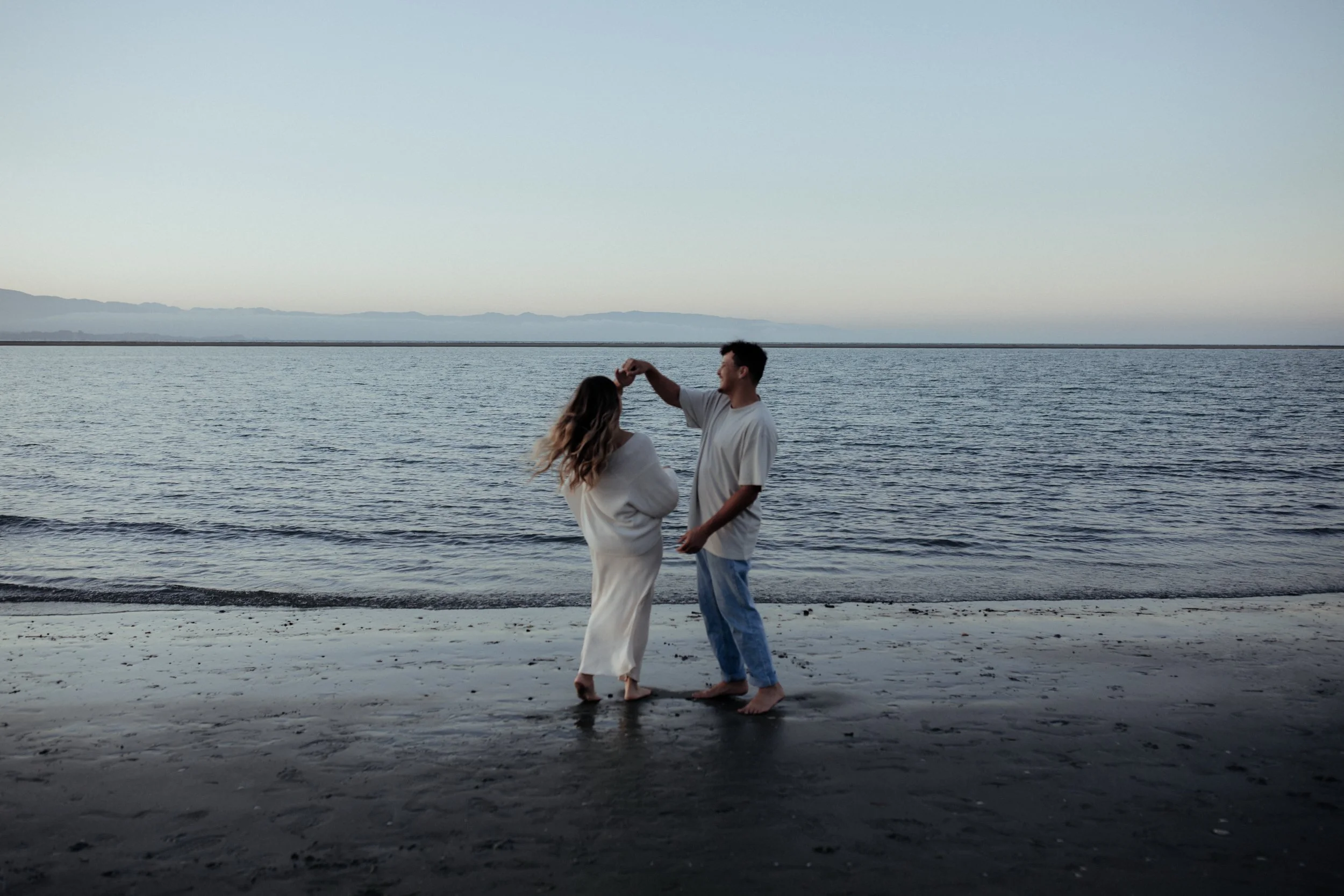 Natural maternity shoot with couple at a beach in Nelson, New Zealand.