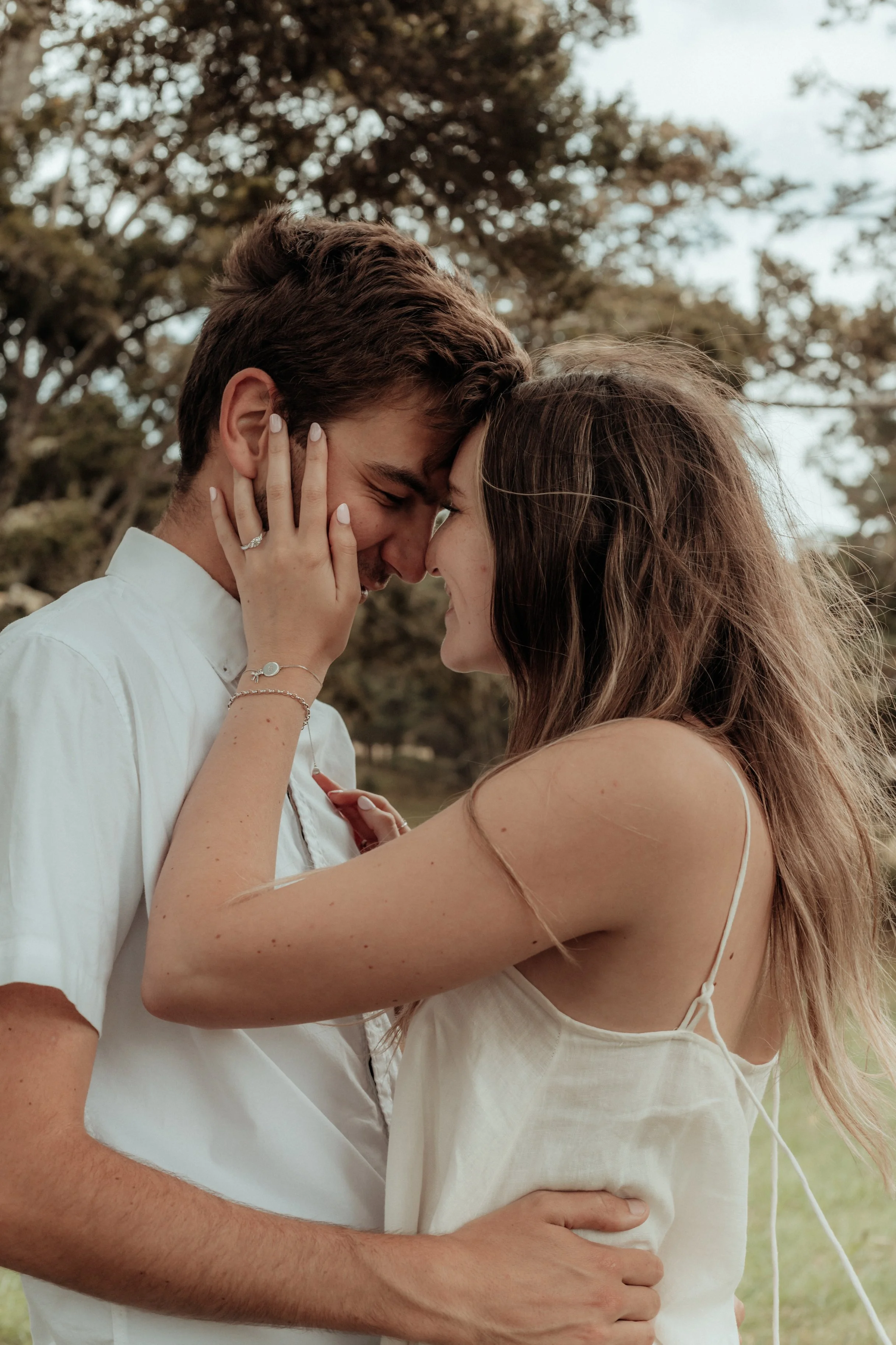 Couple embracing during natural engagement session in Whangarei, Northland.