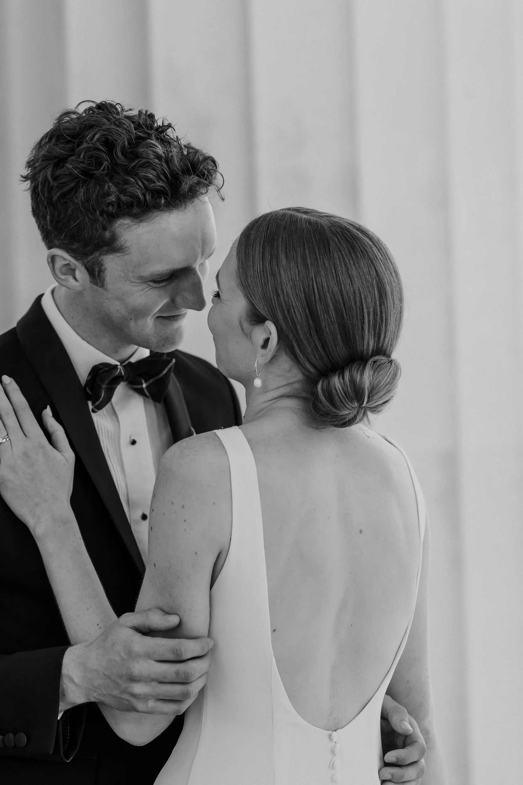 Emotional candid moment between bride and groom at Auckland wedding.
