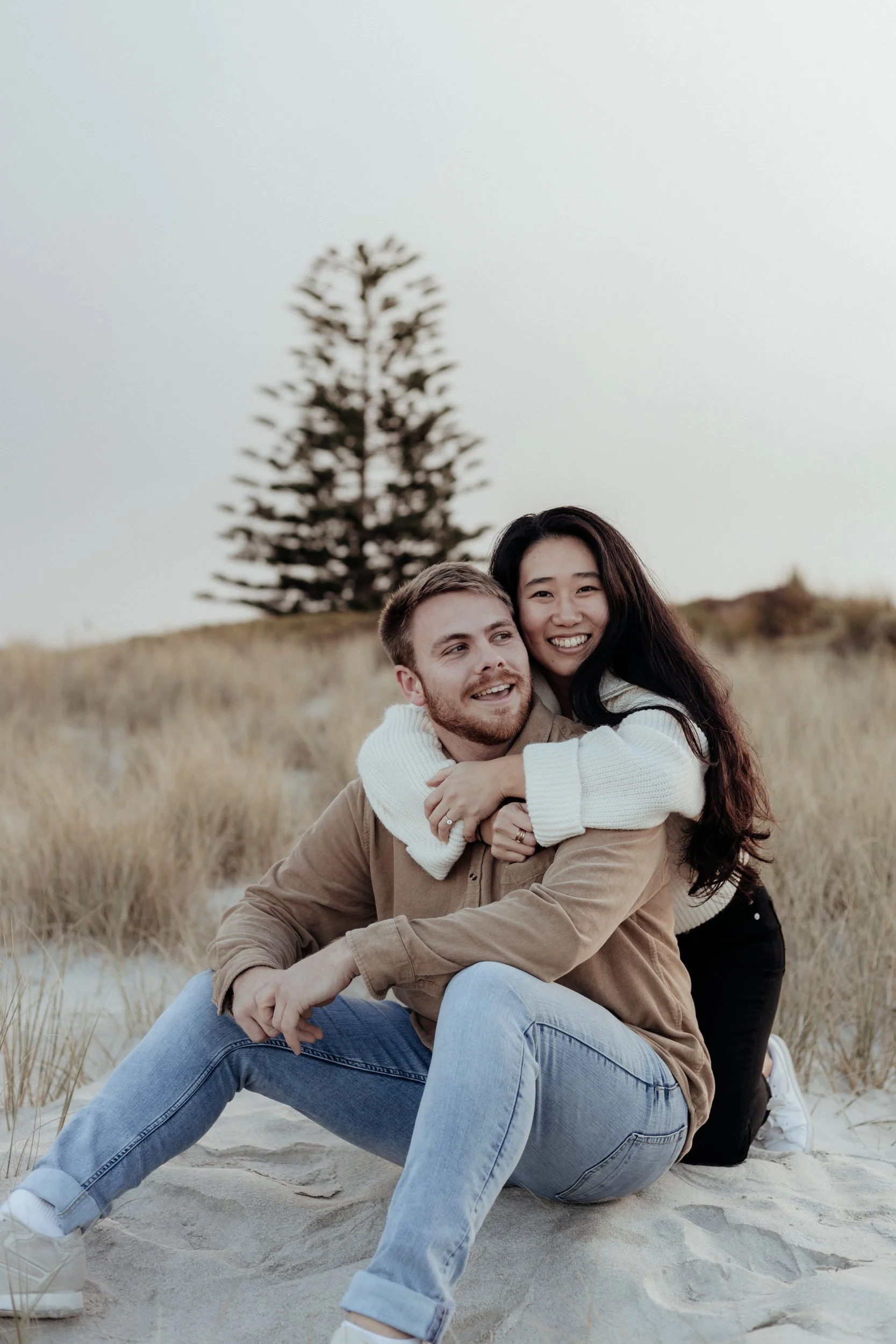 Relaxed couples session on Northland beach at golden hour.