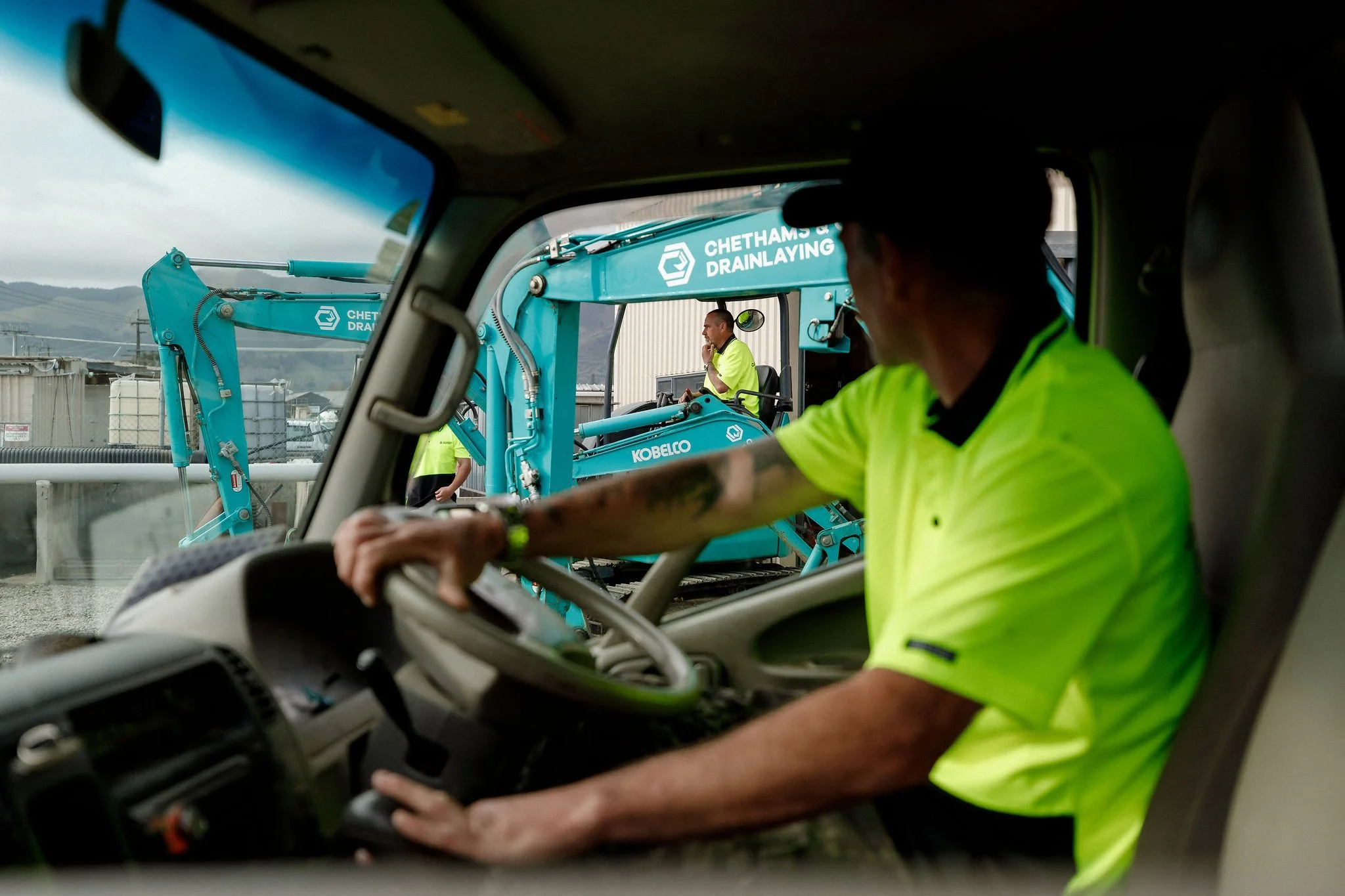 Driver with Kobelco digger driver in the background - Chethams & Co Drainlaying.jpg