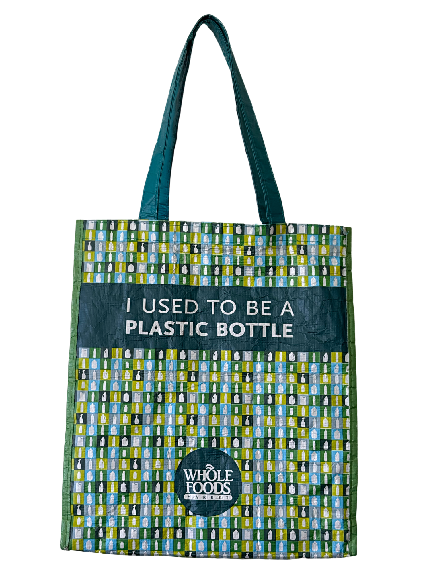 Reusable shopping bag with a pattern of bottles and a message that says, 'I used to be a plastic bottle,' from Whole Foods Market.