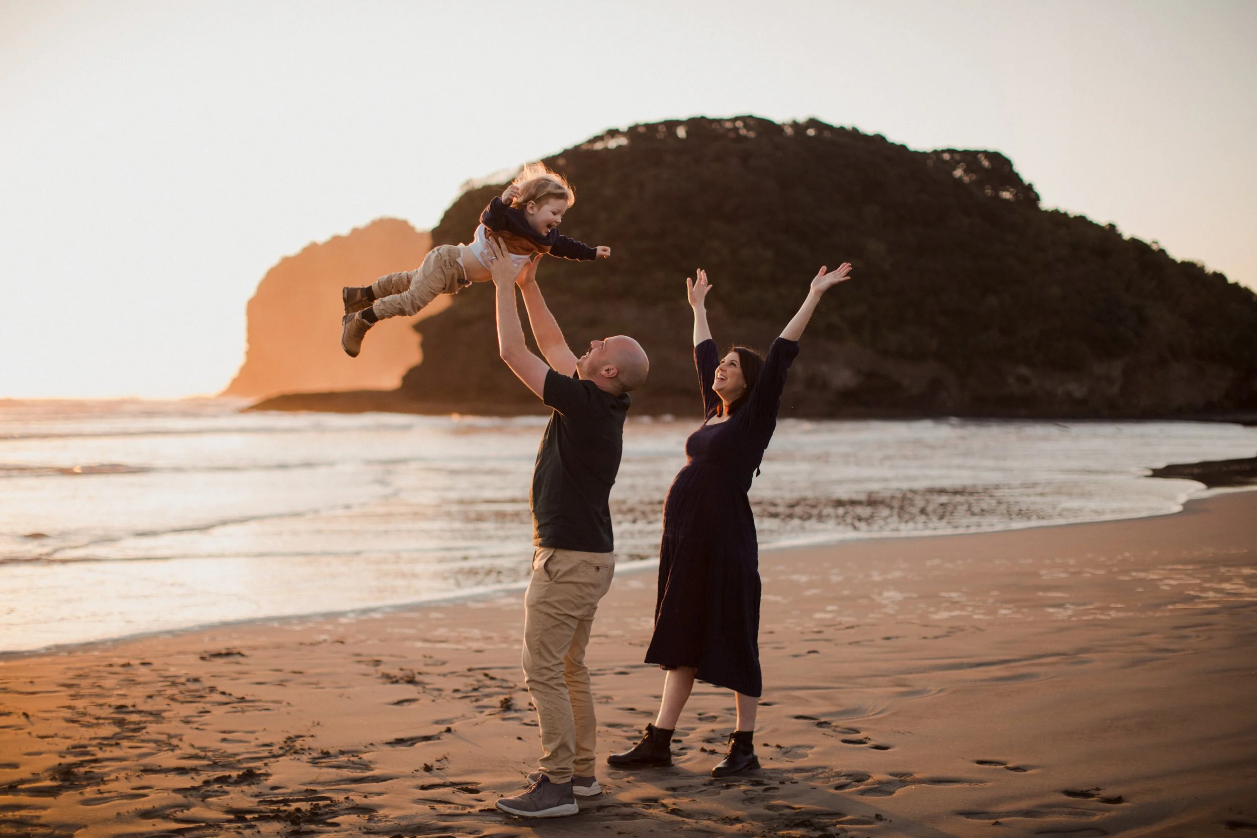Maternity photography session with toddler at Bethells Beach, Auckland