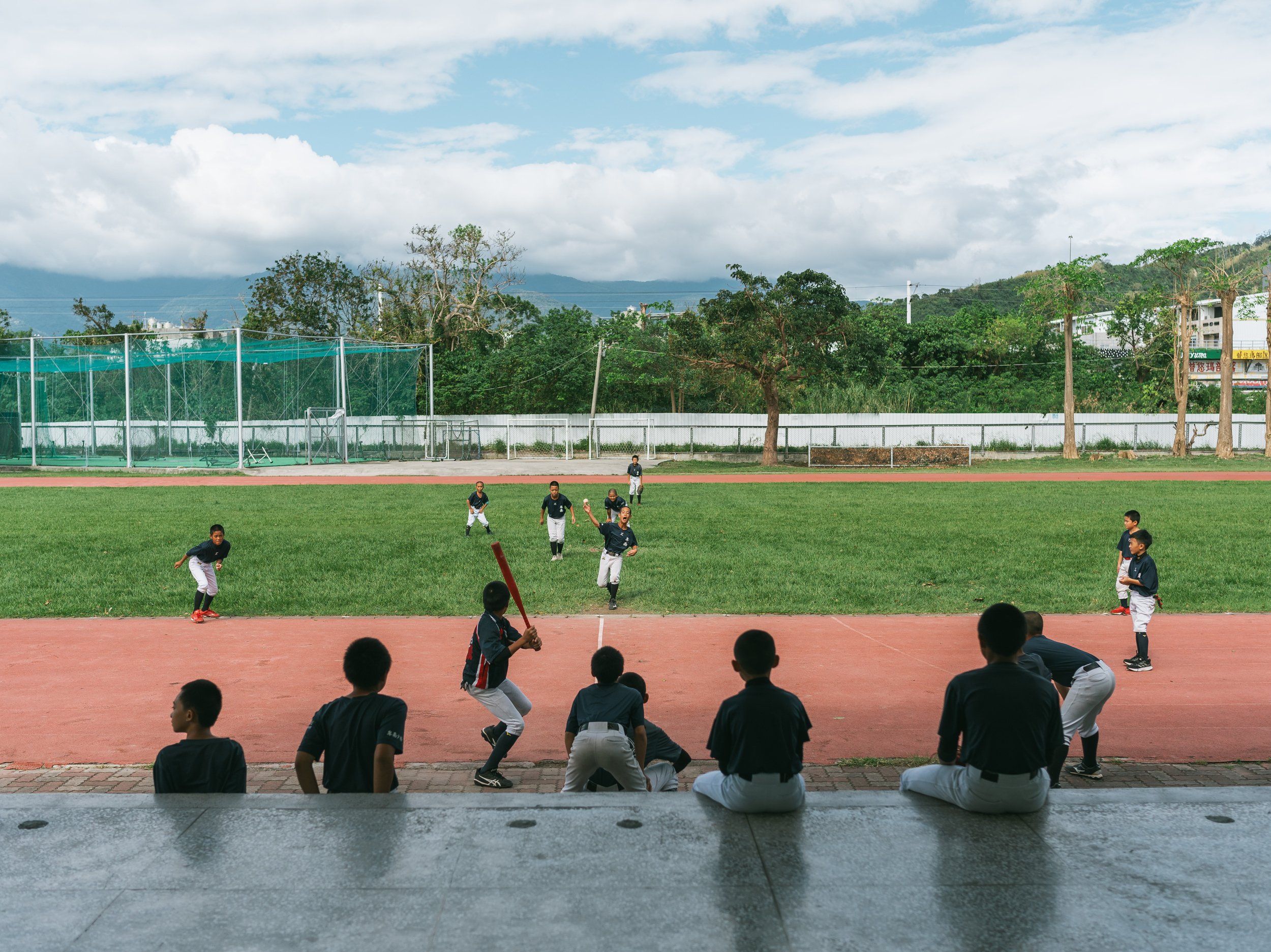 The baseball sports program students play baseball during their break at Bei-Nan Elementary School in Taitung.