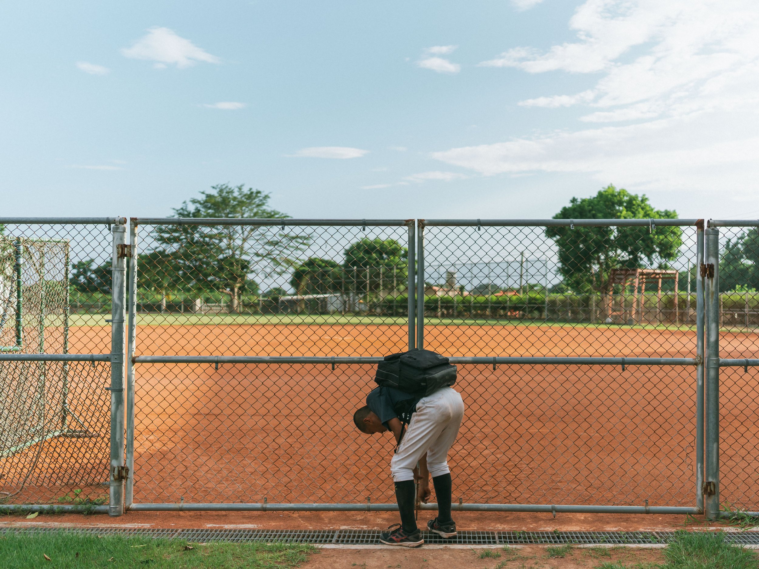 Capitain Yeh Hao-yu from Team A of Bei-Nan Elementary School closes baseball field after training.