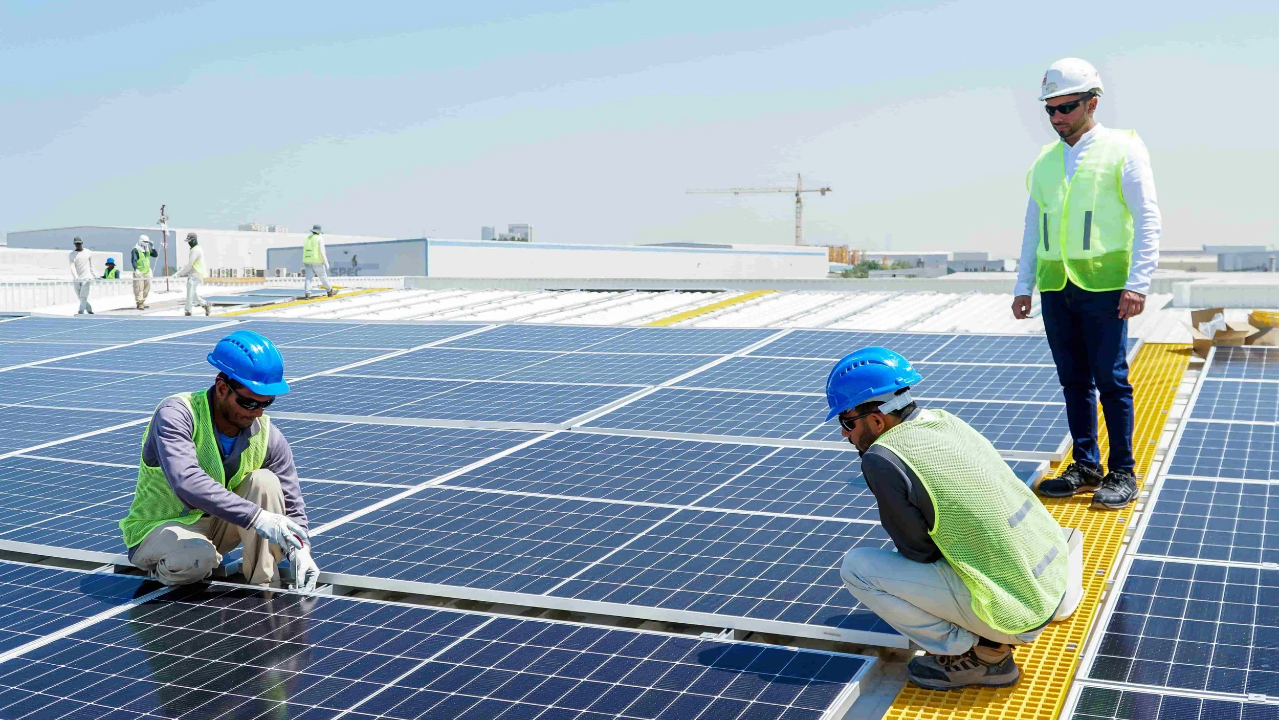 Workers Fixing Solar Panels.jpg