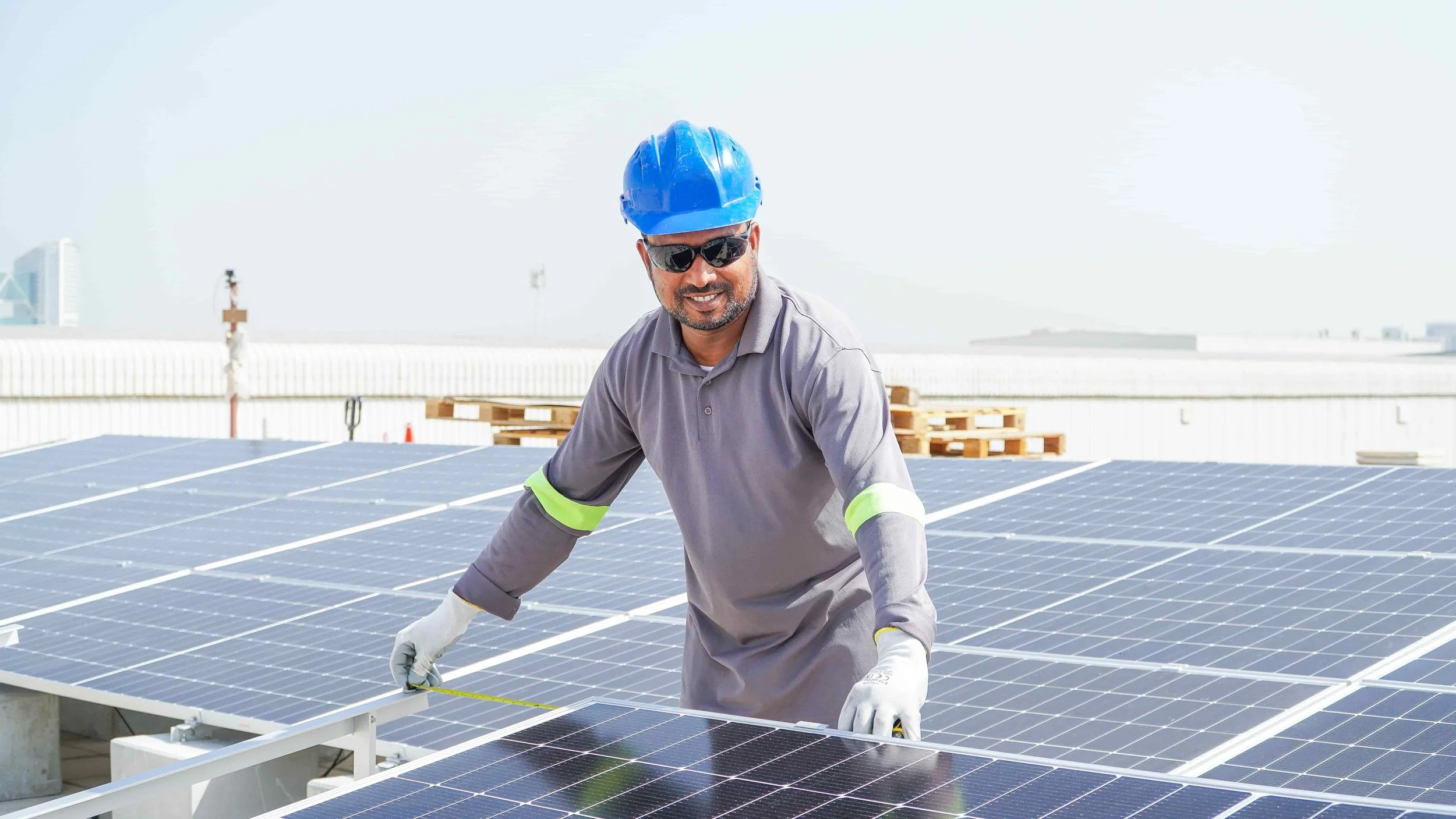 Worker Measuring Solar Panel Railing.jpg