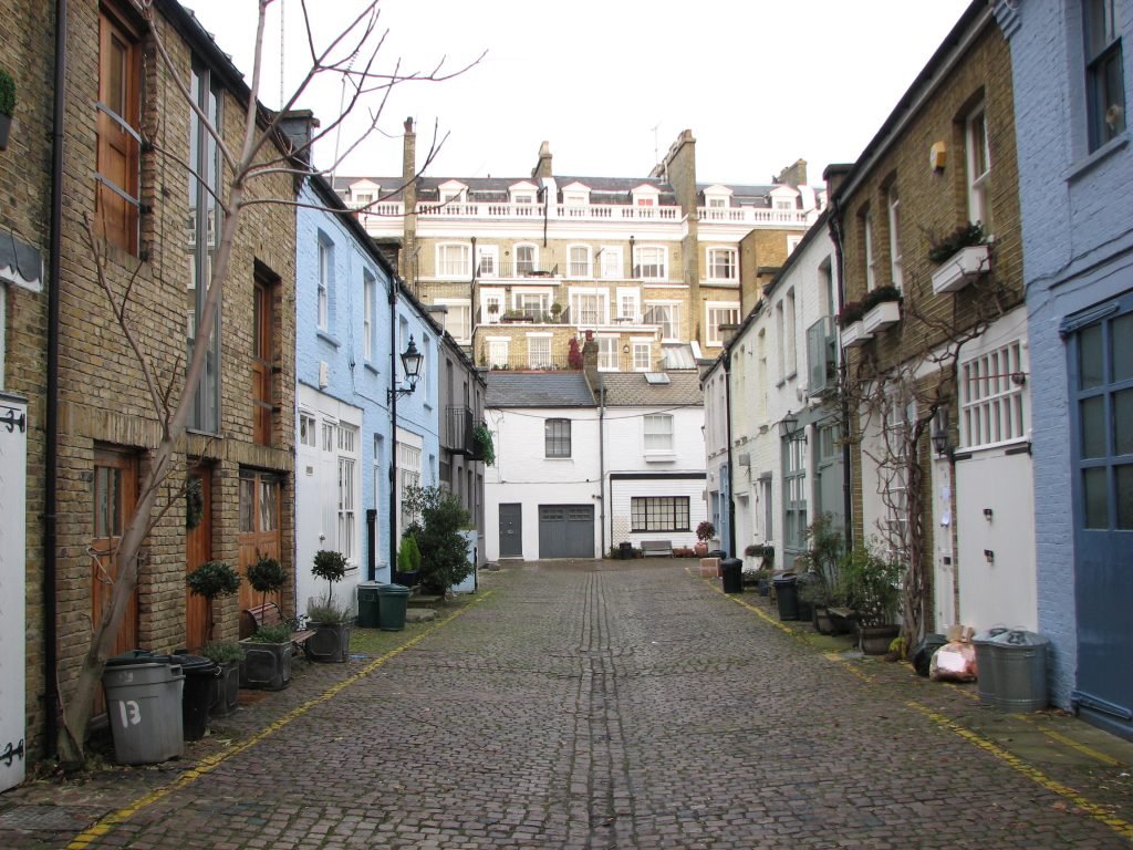 Cobbled street with terrace houses both sides to convey Party Wall issues