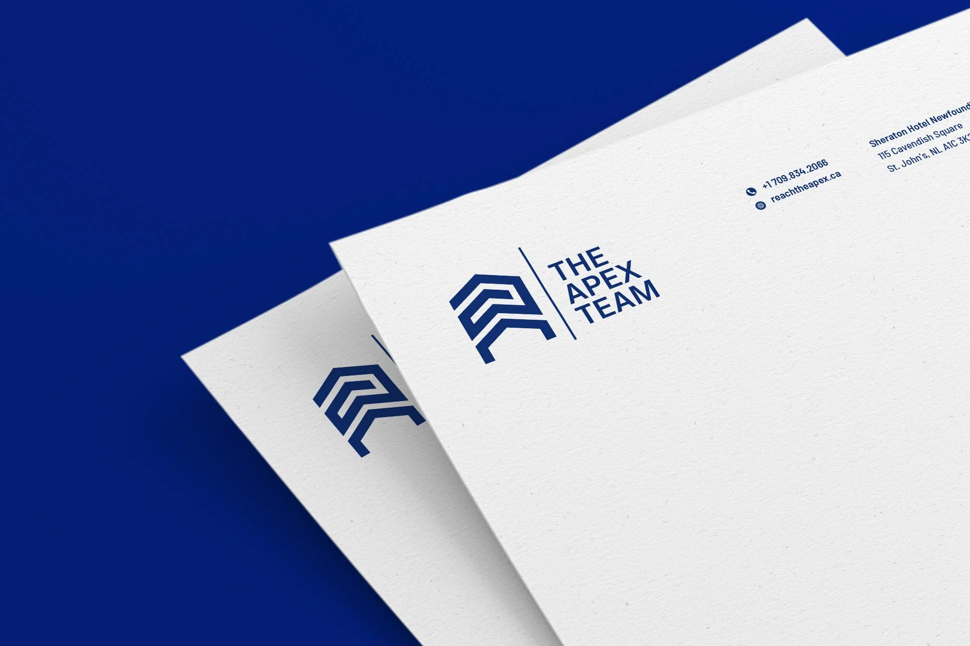 The Apex Team branded letterhead — white paper with navy logo fanned out on a deep blue background, showing the real estate brand print collateral.
